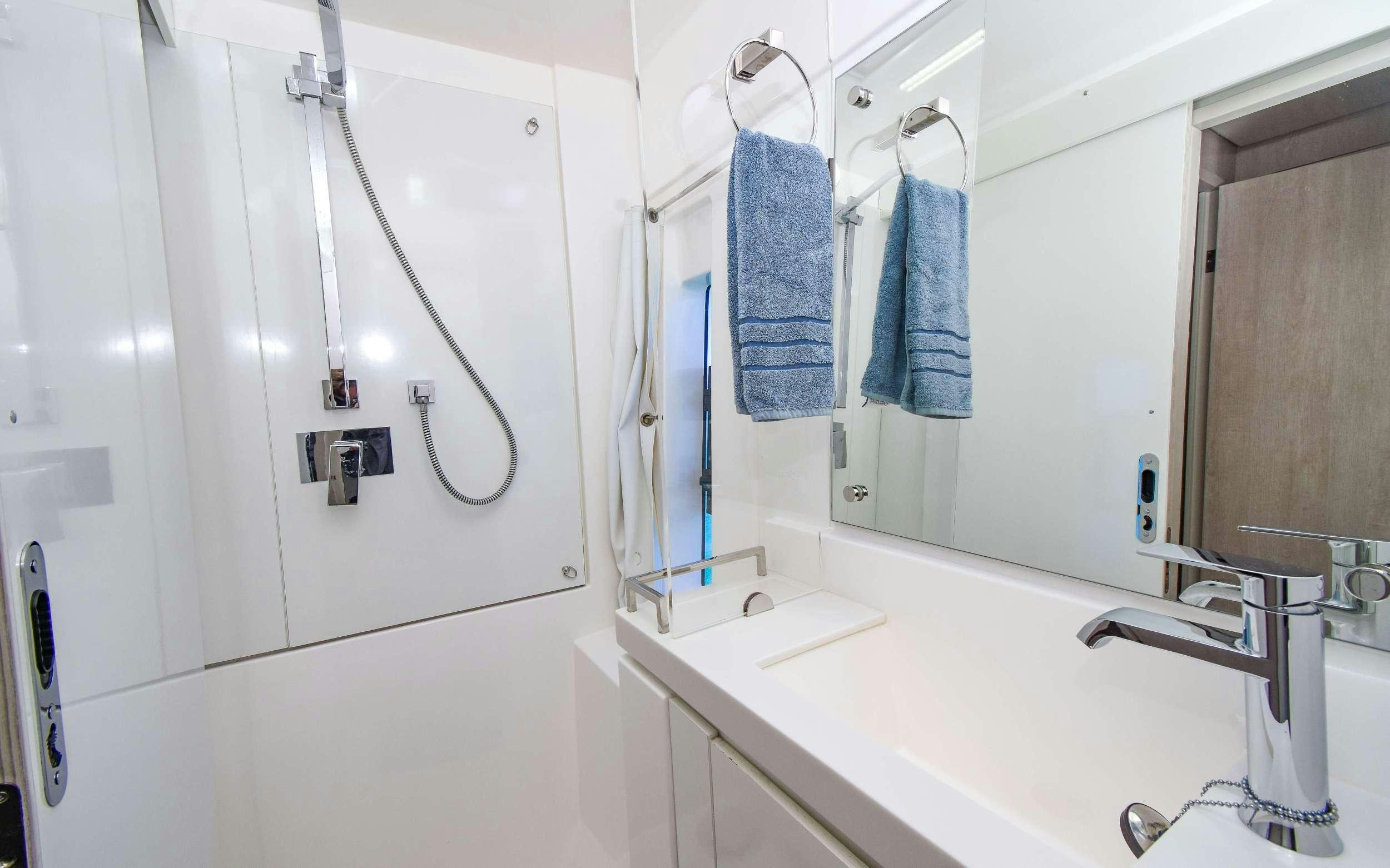 a bathroom with a sink and a mirror aboard LEEWAY Yacht for Charter