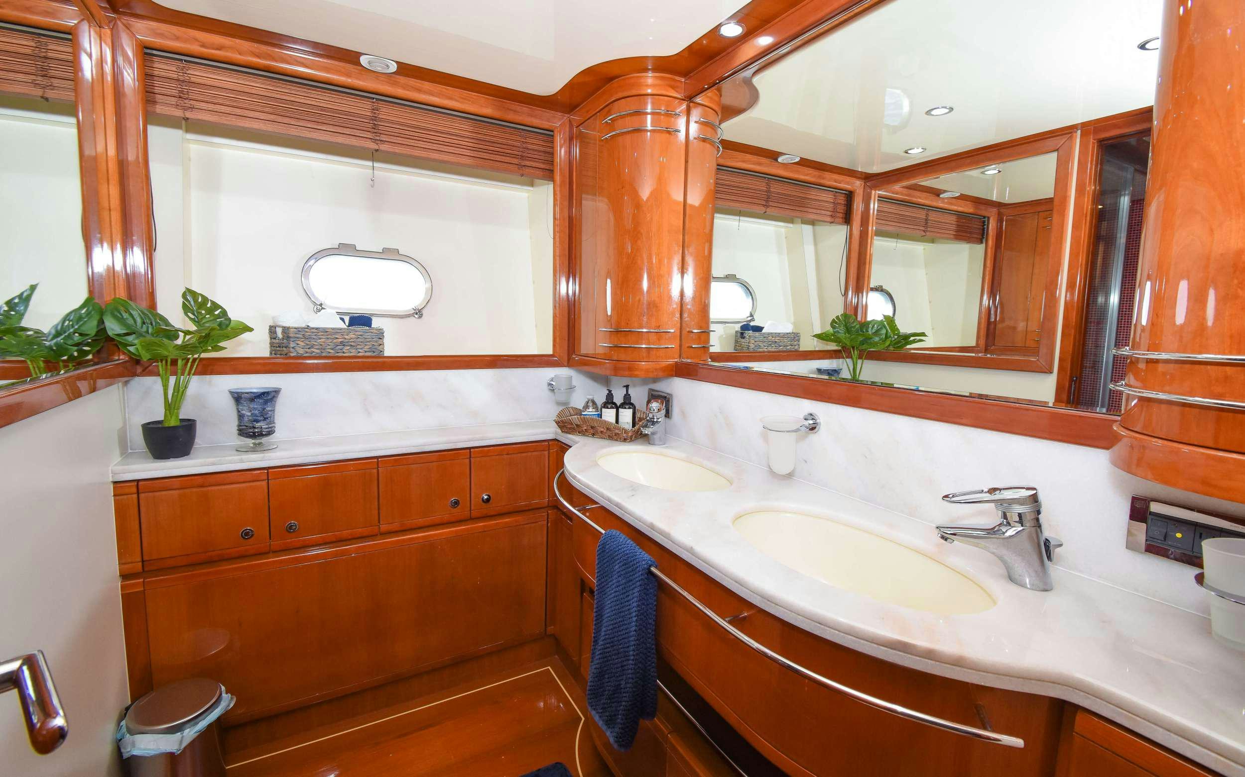 a bathroom with a sink and a mirror aboard INDULGE II Yacht for Charter