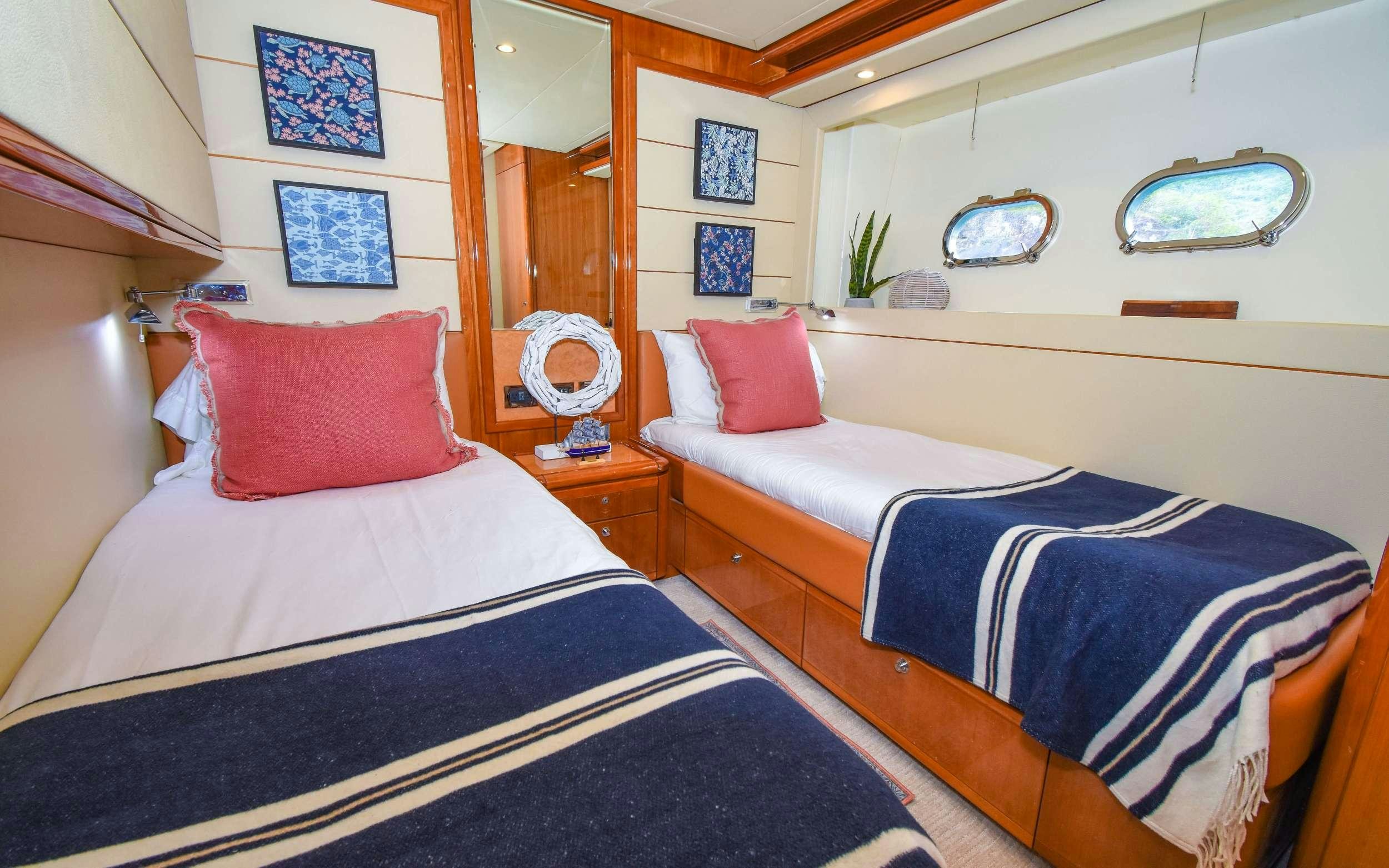 a couple of beds in a room aboard INDULGE II Yacht for Charter