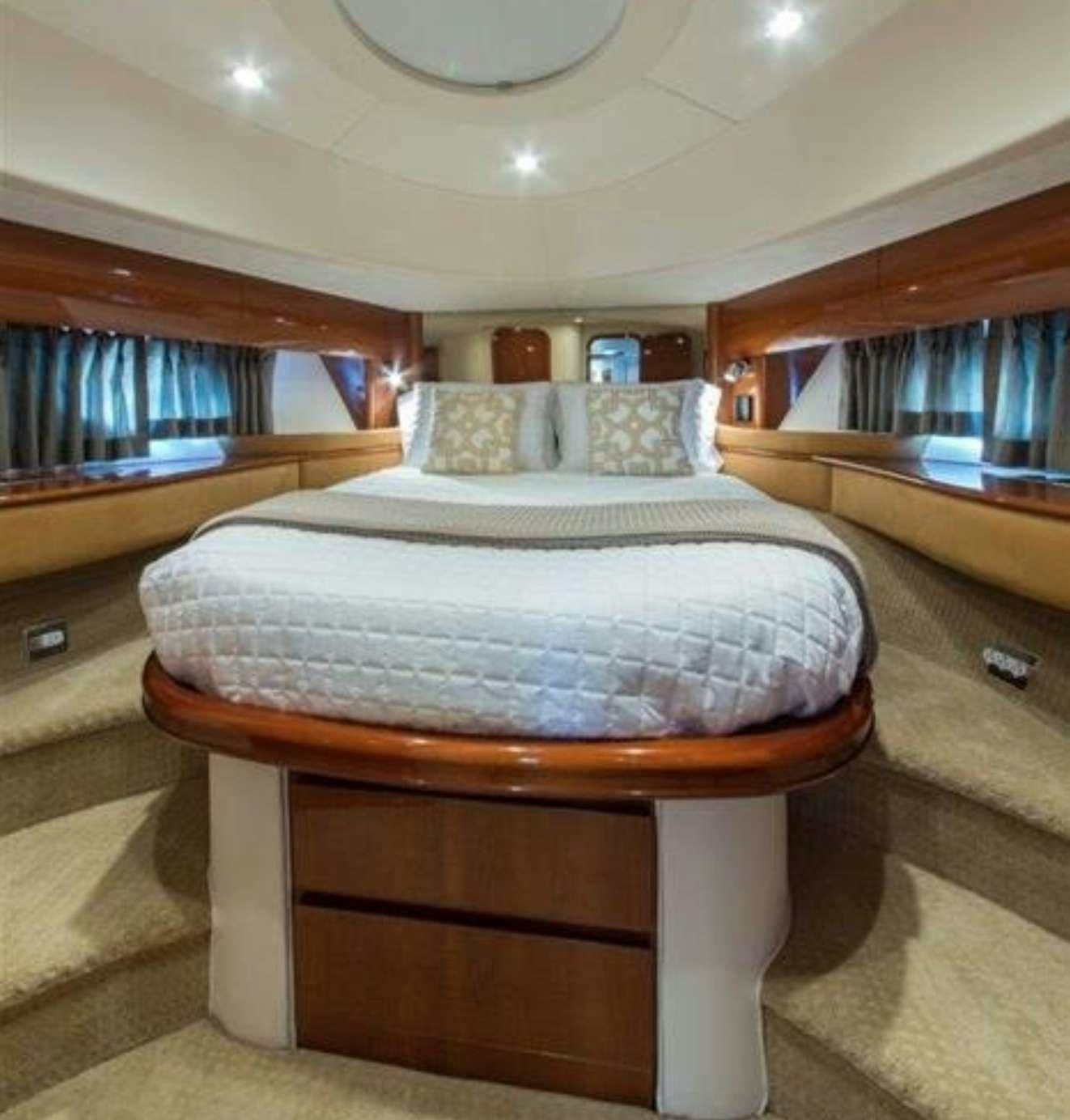 a bed with a white cover aboard SWEET THING Yacht for Charter