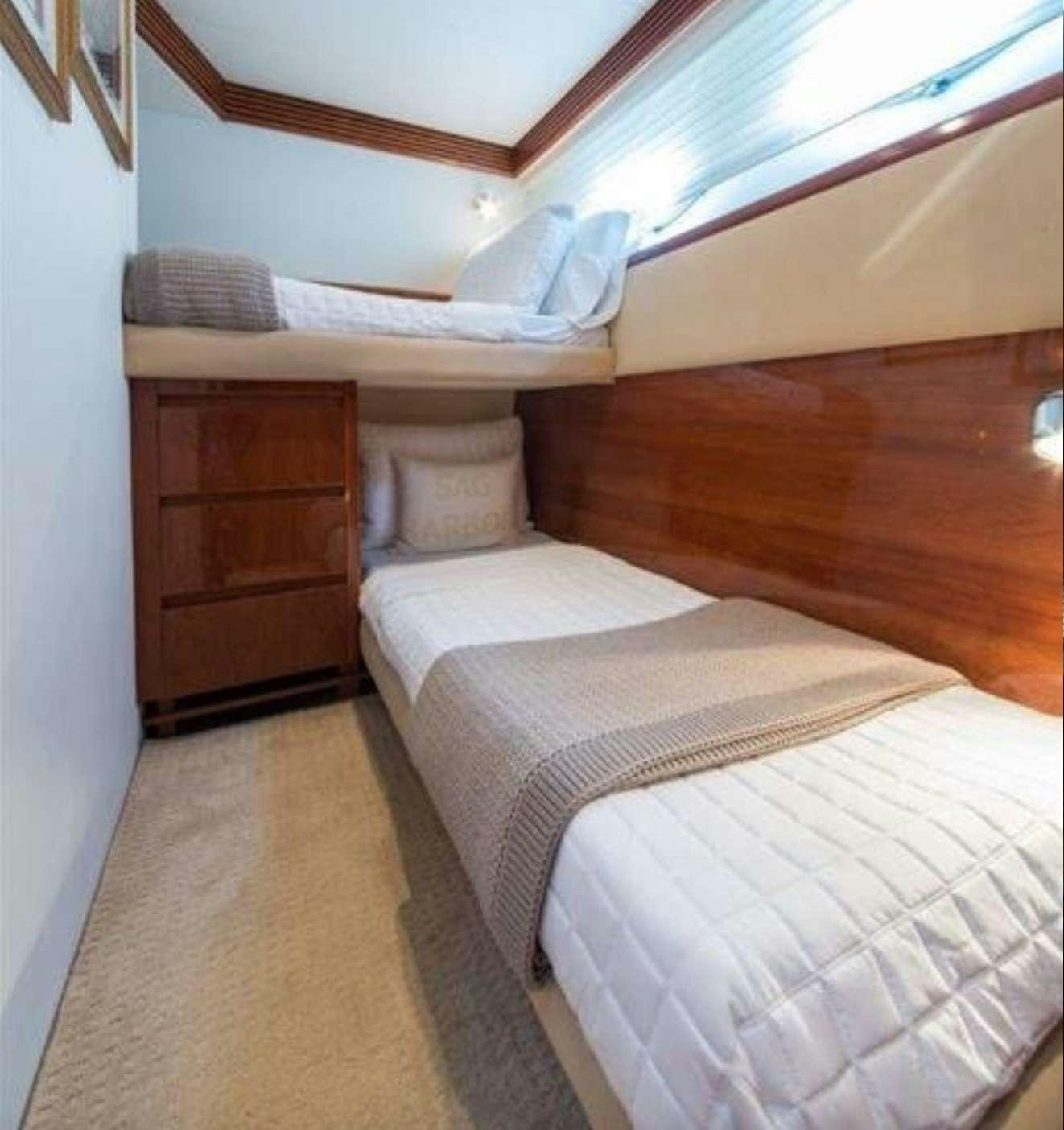 a bed with white sheets aboard SWEET THING Yacht for Charter