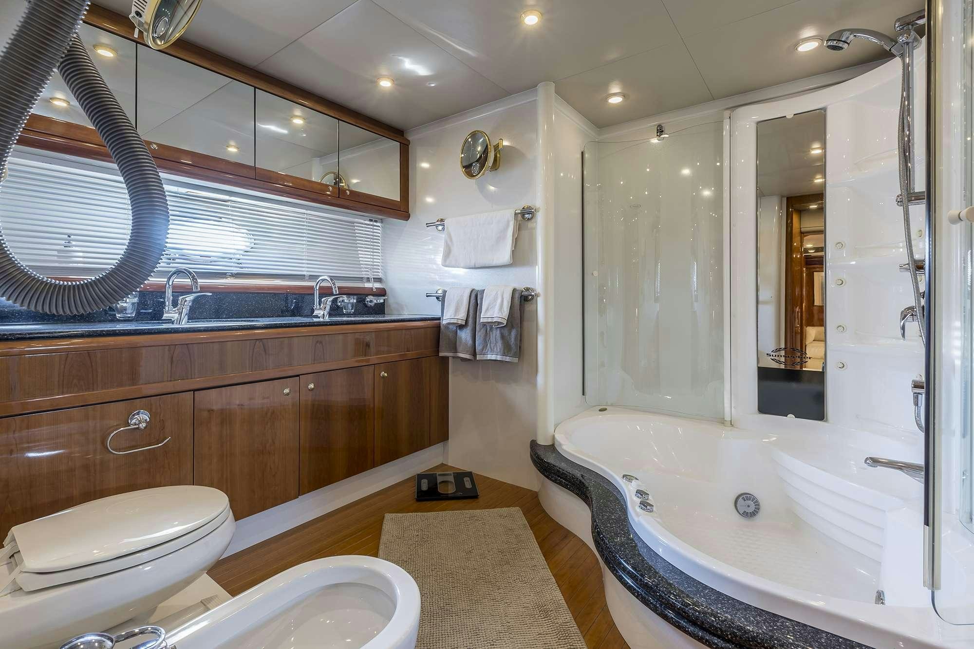a bathroom with a tub sink and toilet aboard SKYWATER Yacht for Charter