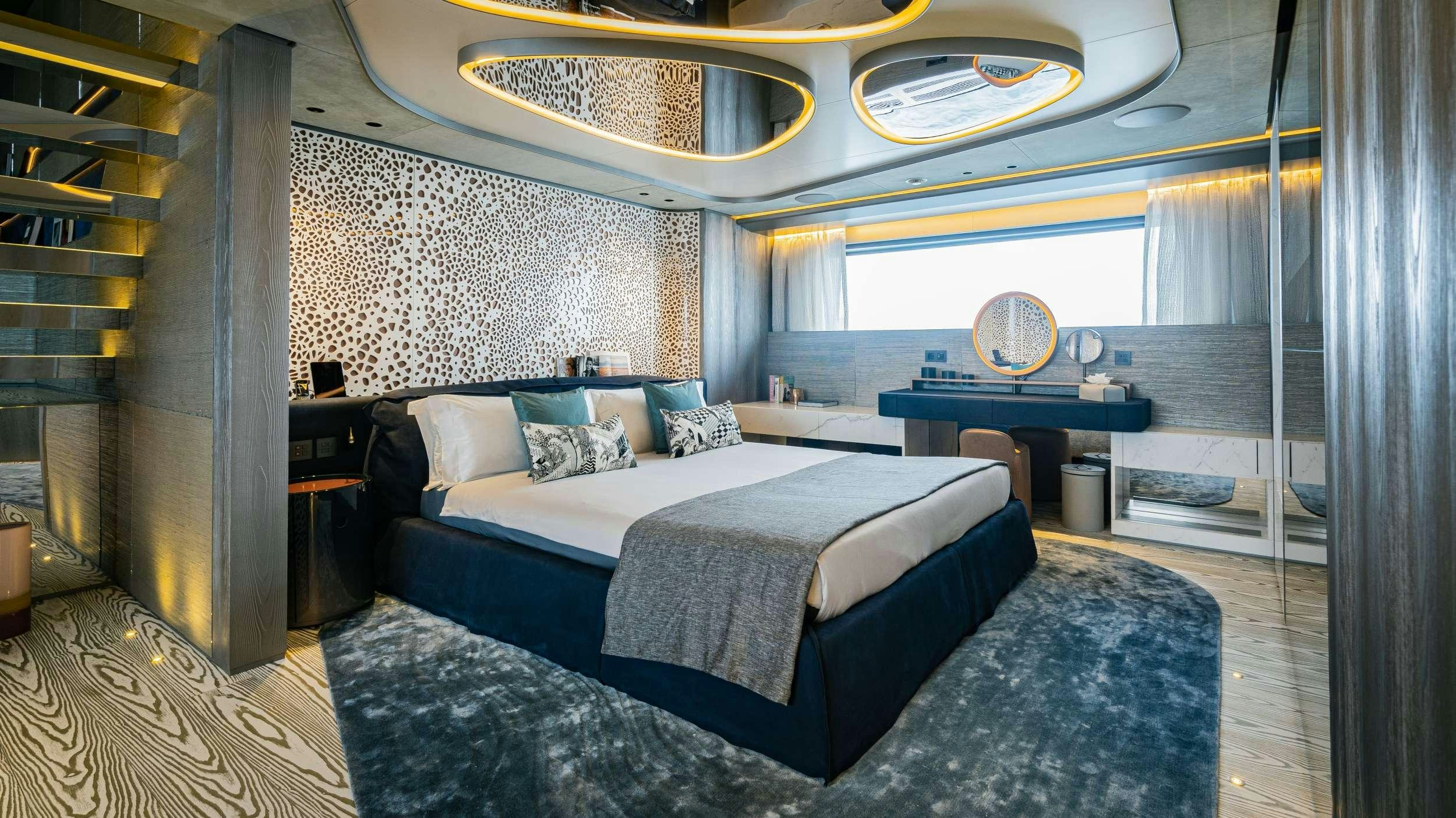 a bedroom with a bed and a table aboard PANDION PEARL Yacht for Charter