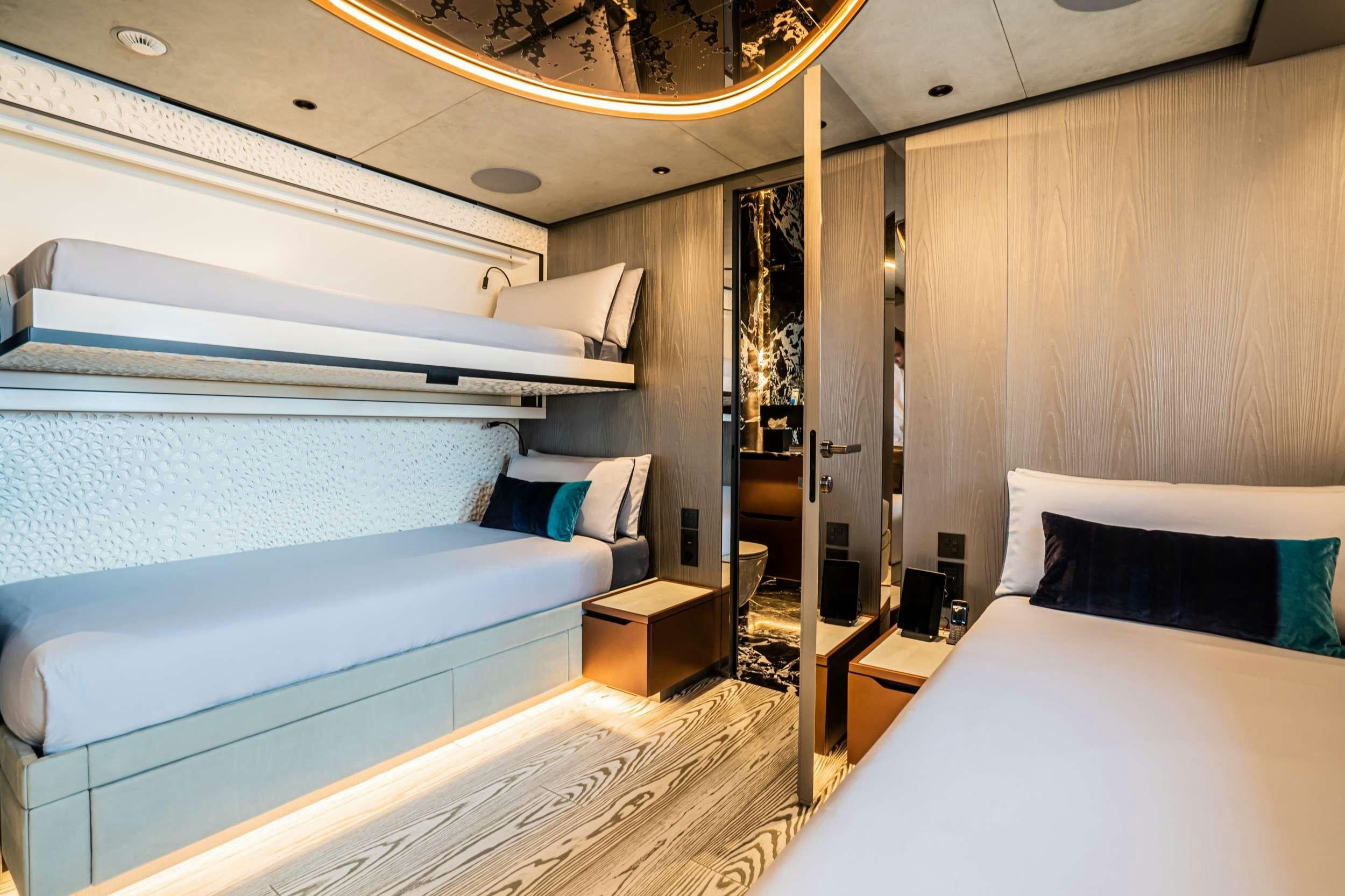 a room with a bed and a mirror aboard PANDION PEARL Yacht for Charter