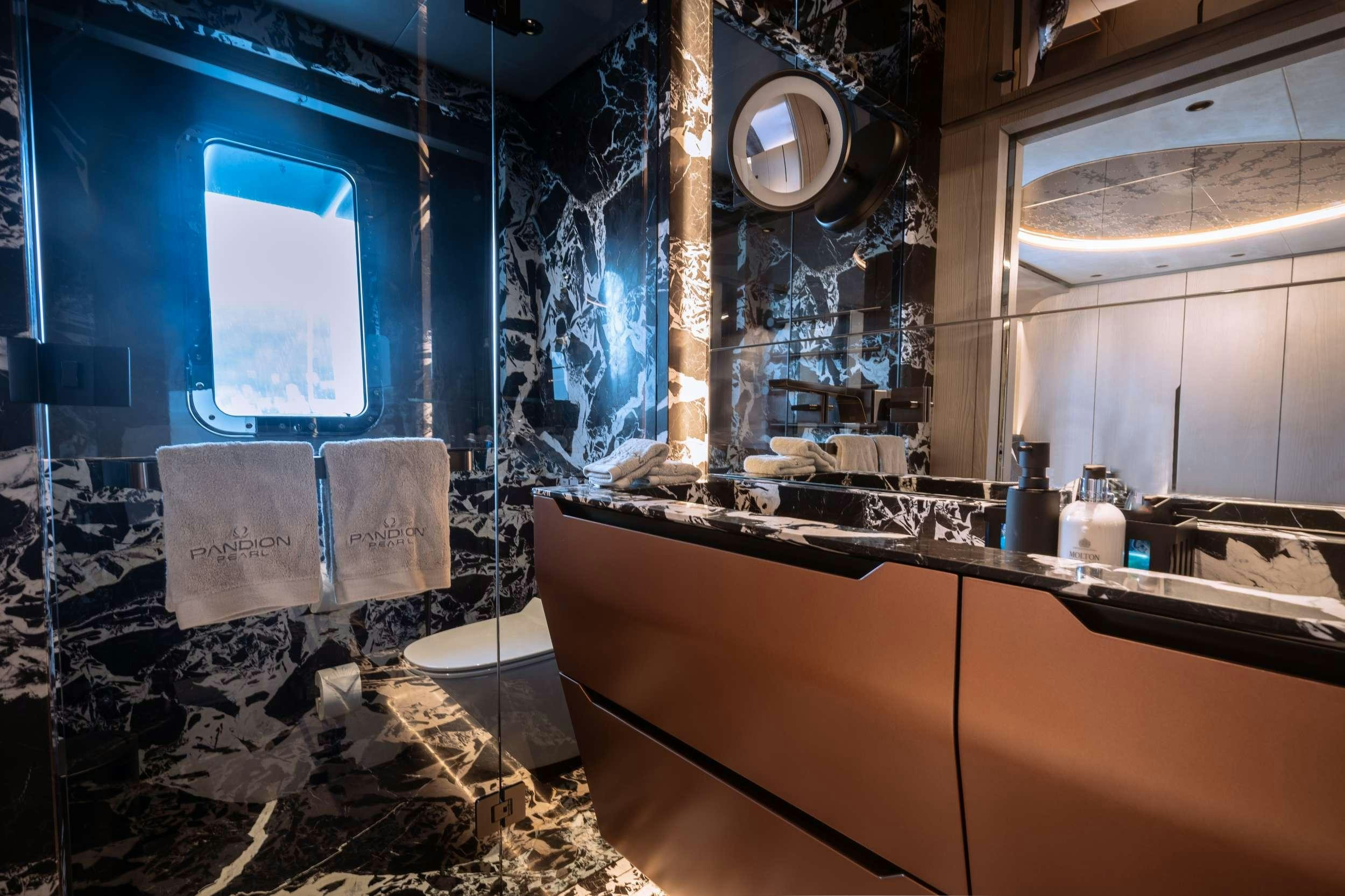 a bathroom with a tub and sinks aboard PANDION PEARL Yacht for Charter