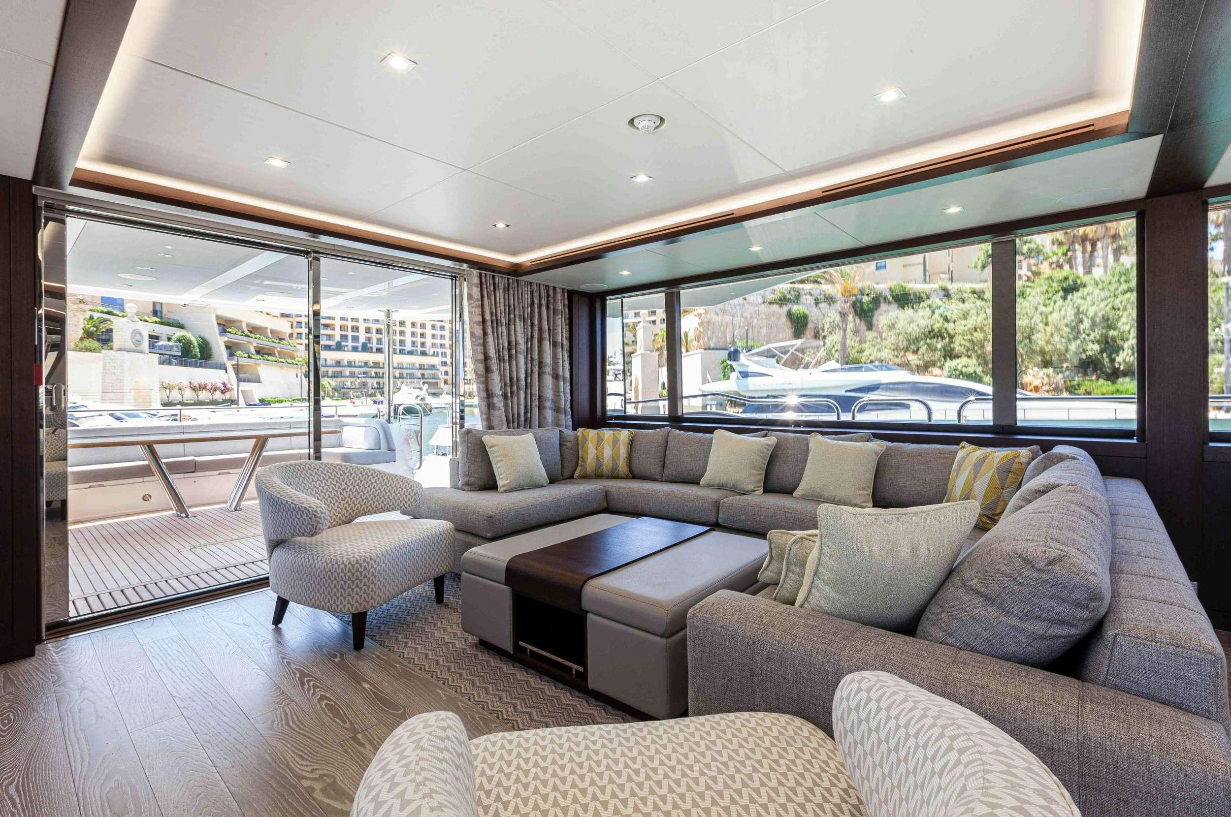 a living room with a large window aboard NEW EDGE Yacht for Charter