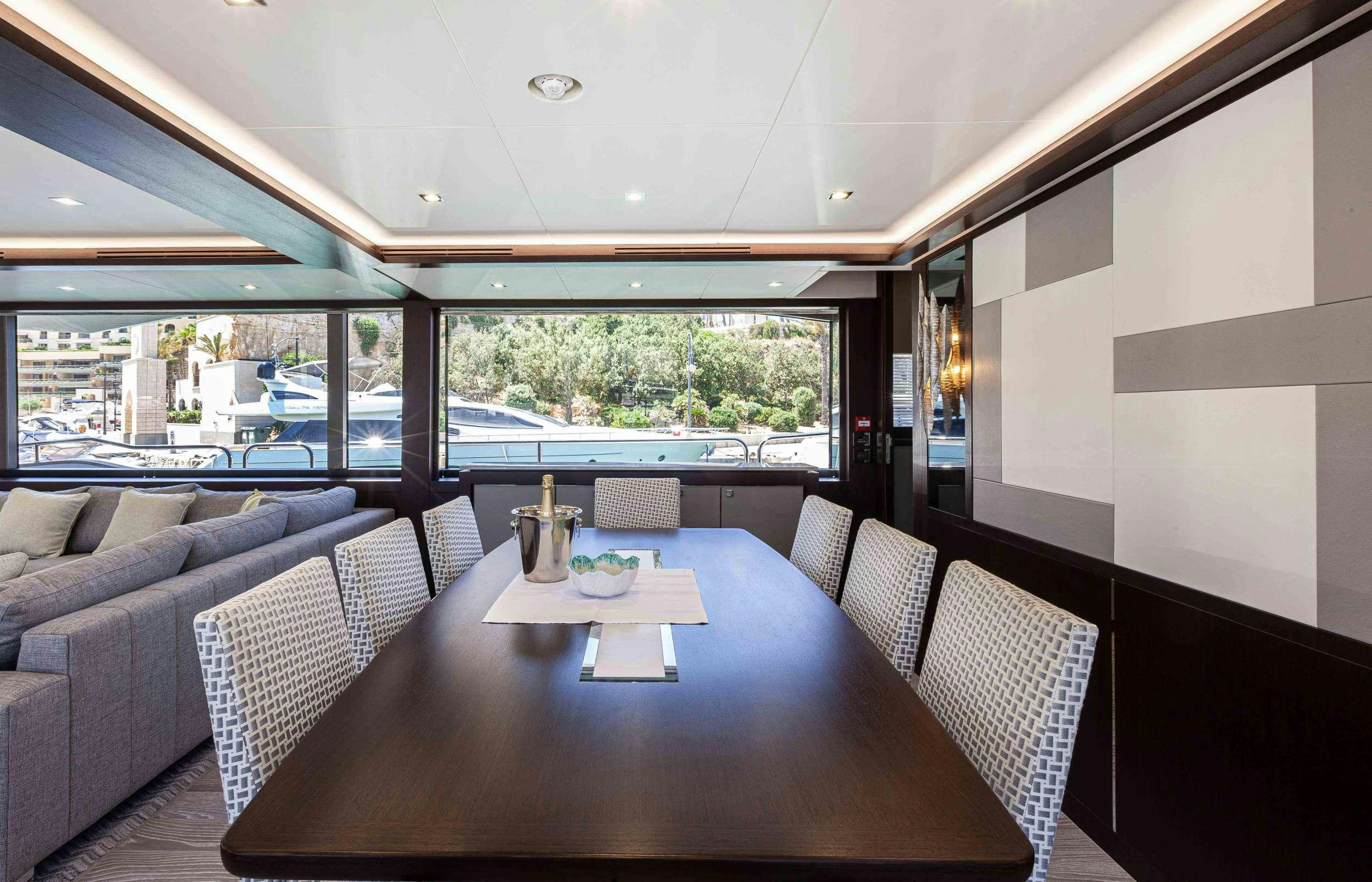 a table and chairs in a room aboard NEW EDGE Yacht for Charter