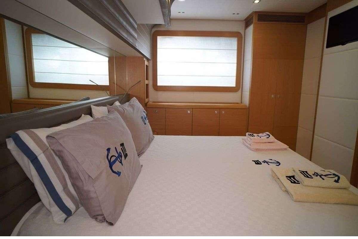 a bed with pillows and a blanket aboard REINE DES COEURS Yacht for Charter