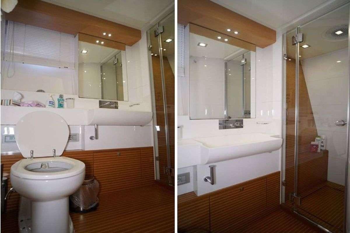 a bathroom with a toilet and bathtub aboard REINE DES COEURS Yacht for Charter