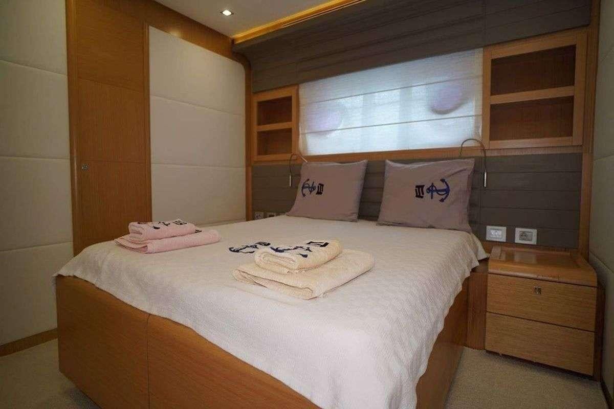 a bed with white sheets and pillows aboard REINE DES COEURS Yacht for Charter