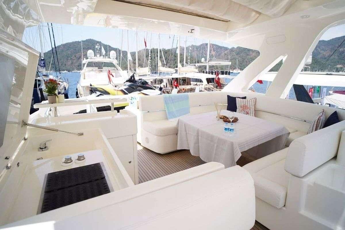a room with a table chairs and a boat in it aboard REINE DES COEURS Yacht for Charter