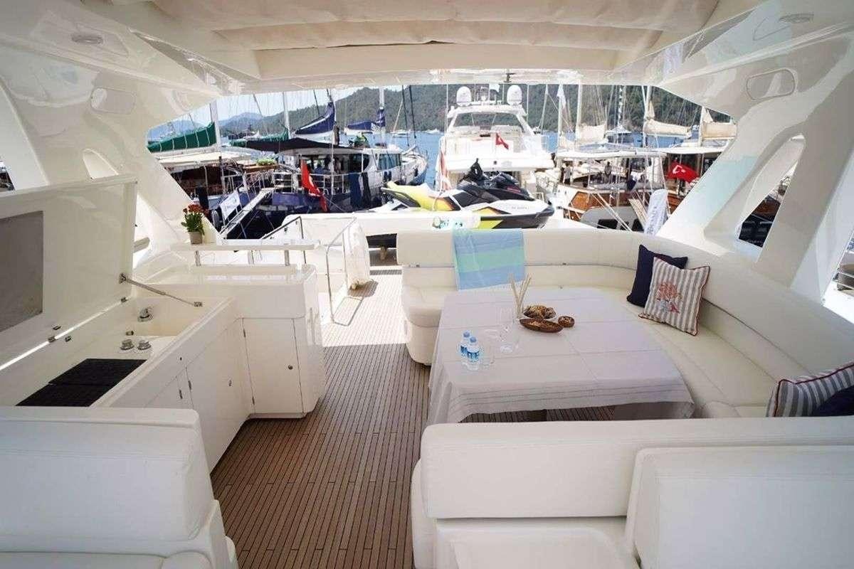 a room with white furniture aboard REINE DES COEURS Yacht for Charter