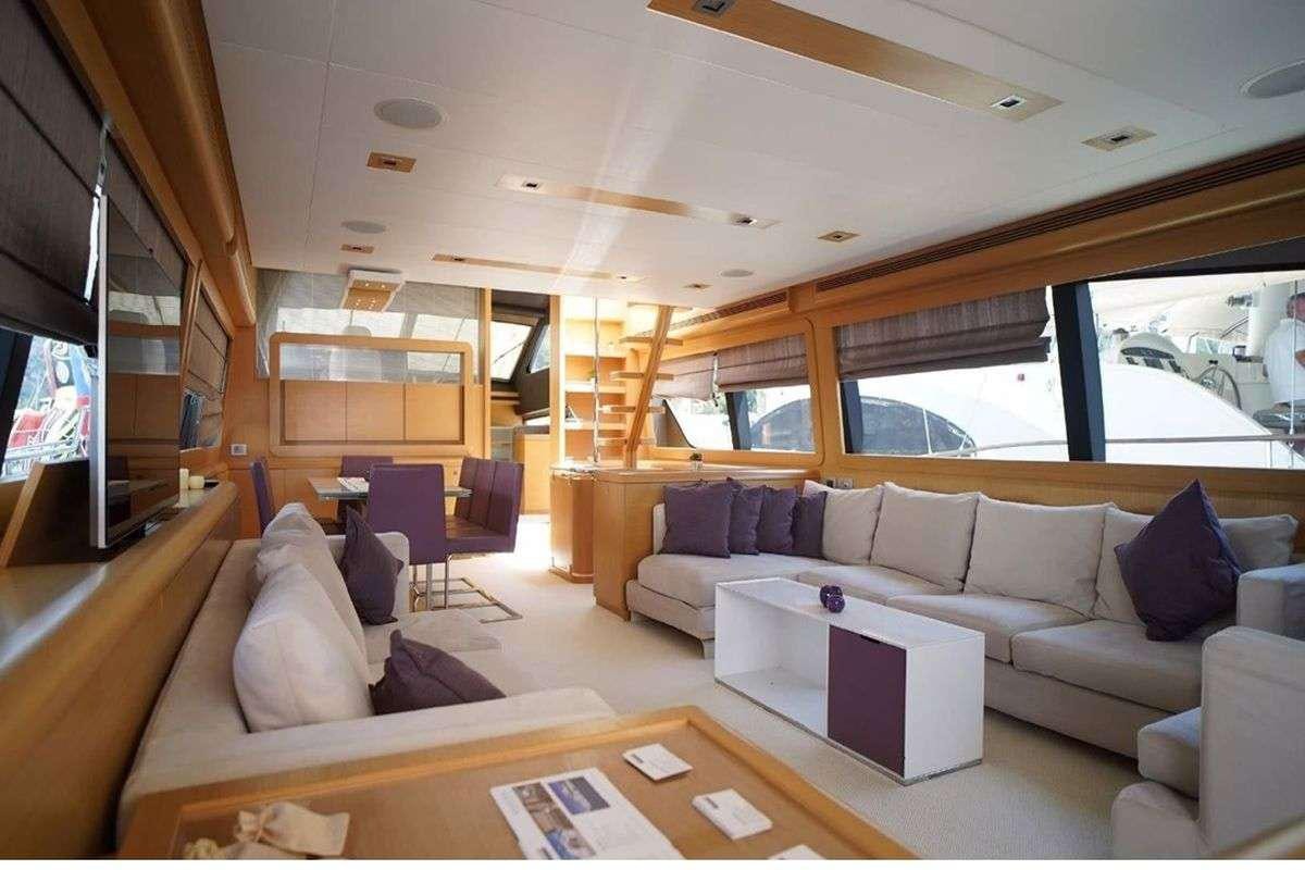 a living room with a couch and a table aboard REINE DES COEURS Yacht for Charter