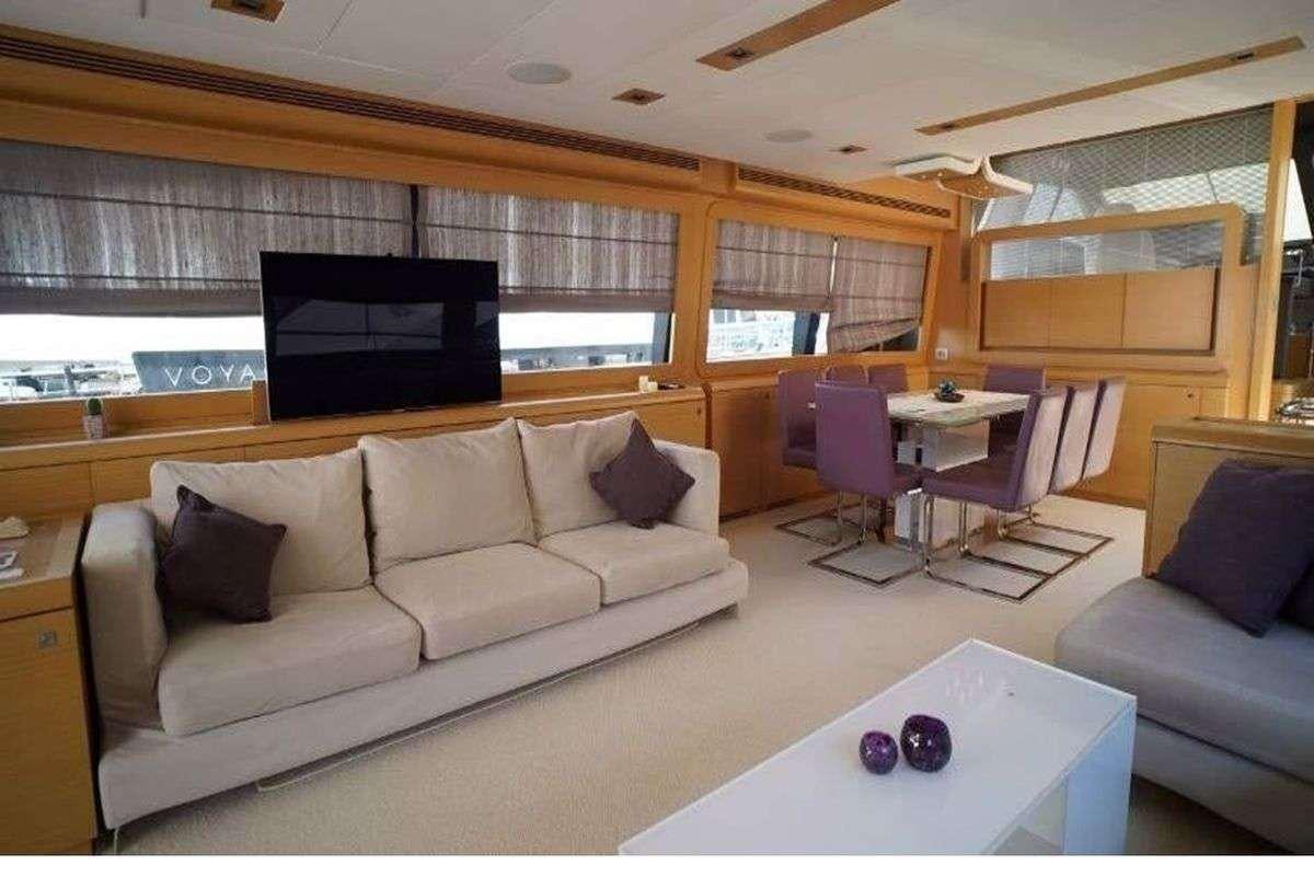 a living room with a couch and a tv aboard REINE DES COEURS Yacht for Charter