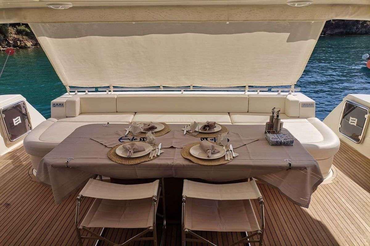 a table with chairs on it next to a pool aboard REINE DES COEURS Yacht for Charter