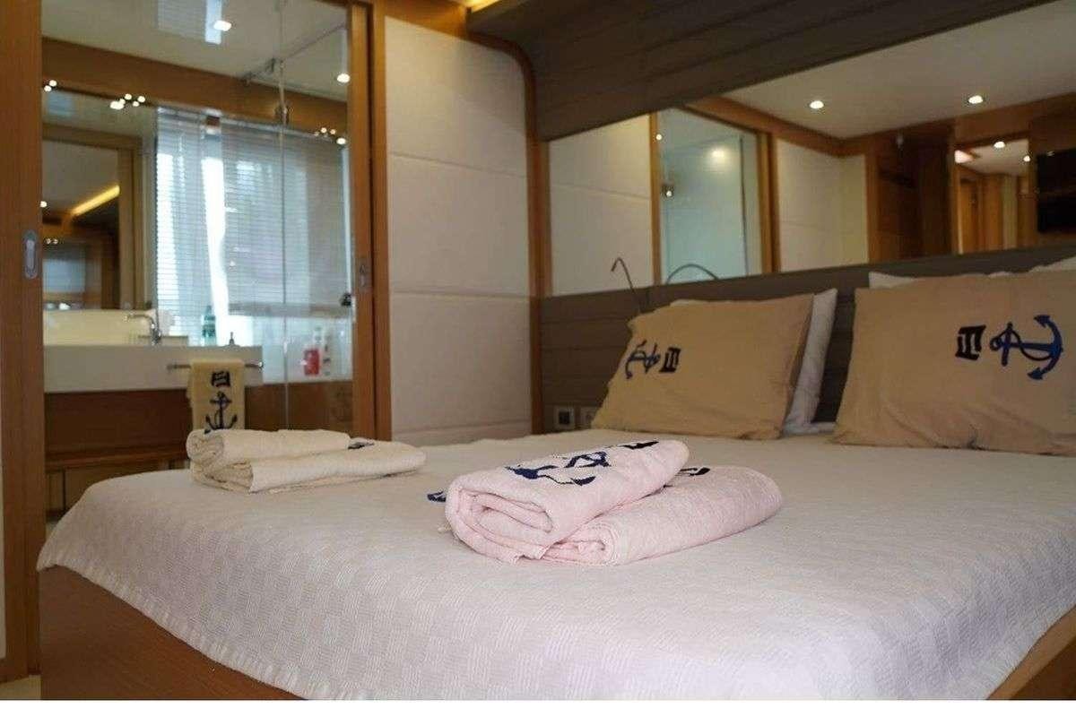 a bed with pillows aboard REINE DES COEURS Yacht for Charter