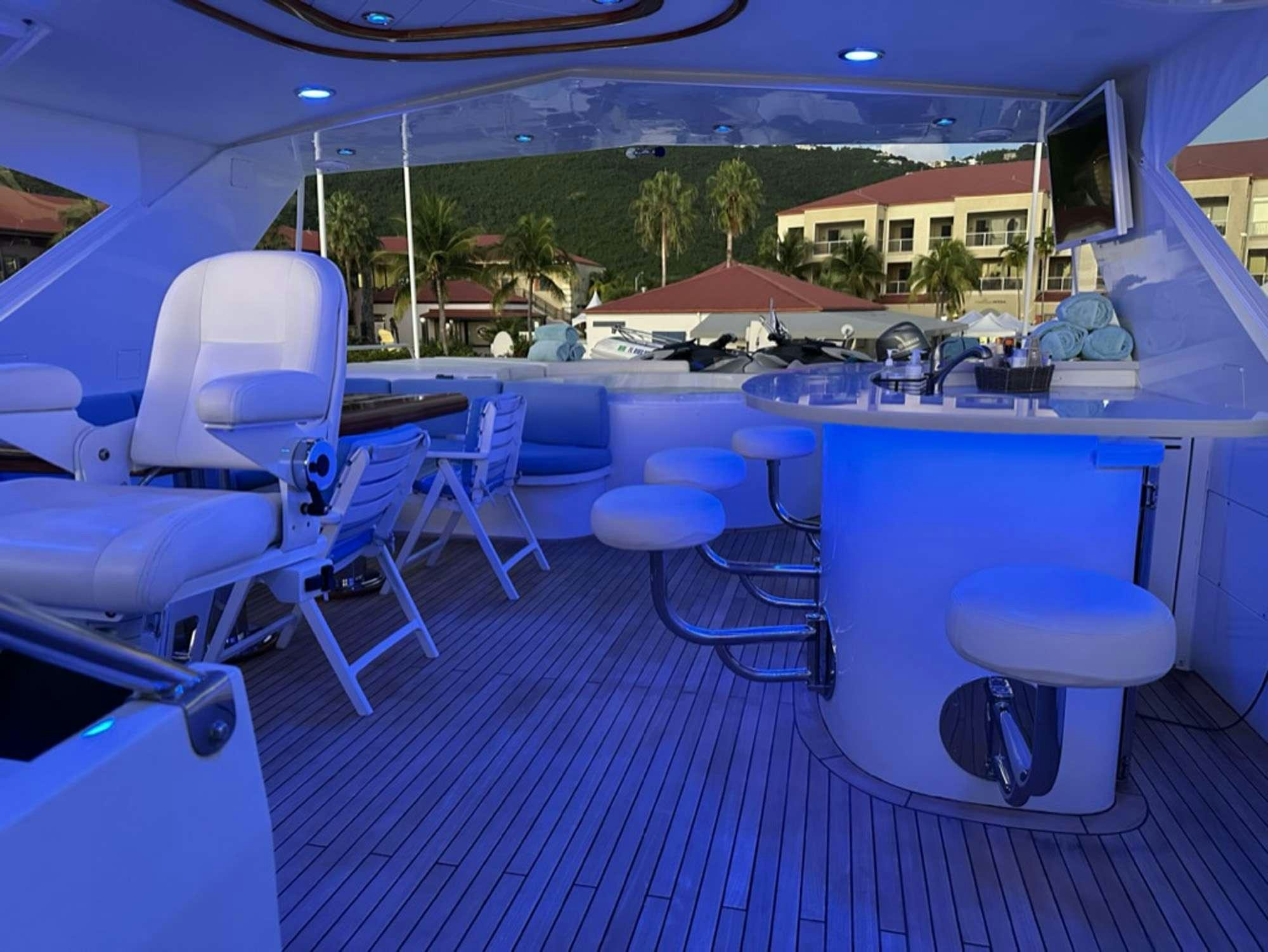a room with a table chairs and a pool table aboard ISLAND GIRL Yacht for Charter