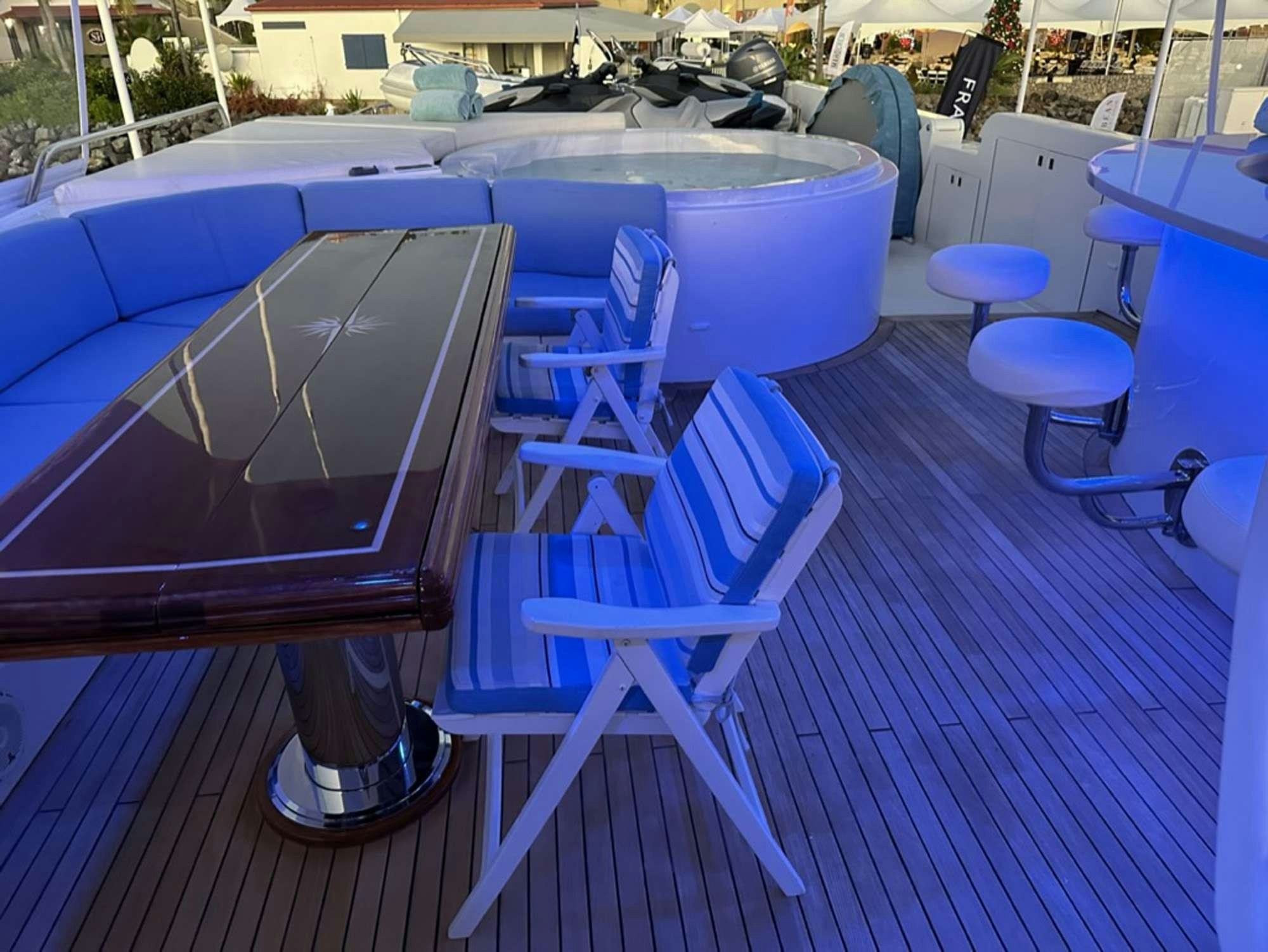 a pool table and chairs on a deck aboard ISLAND GIRL Yacht for Charter