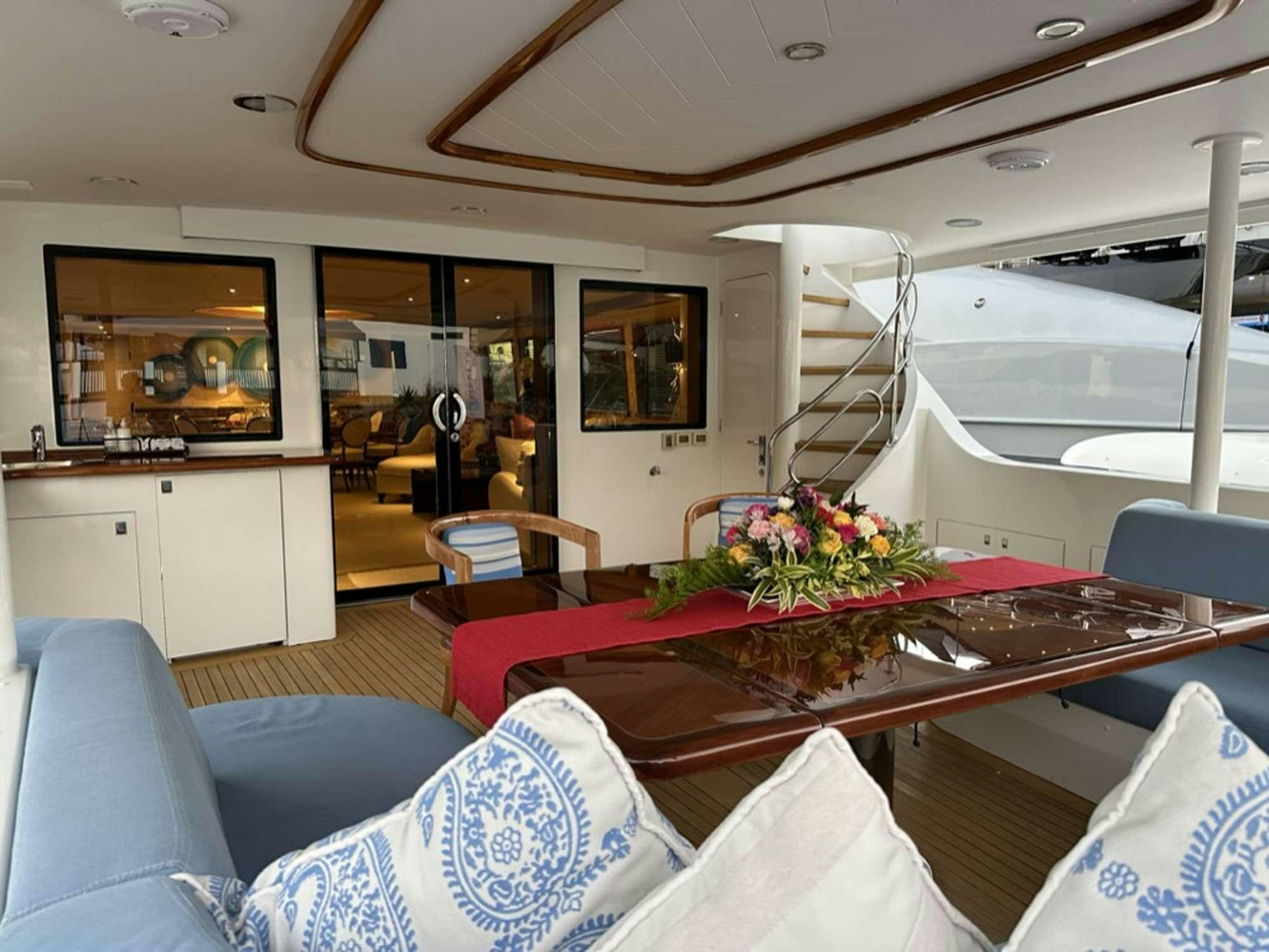 a living room with a table and chairs aboard ISLAND GIRL Yacht for Charter