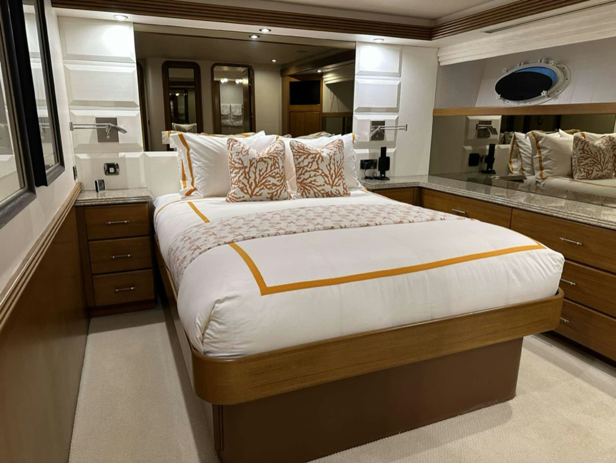 a bedroom with a bed aboard ISLAND GIRL Yacht for Charter