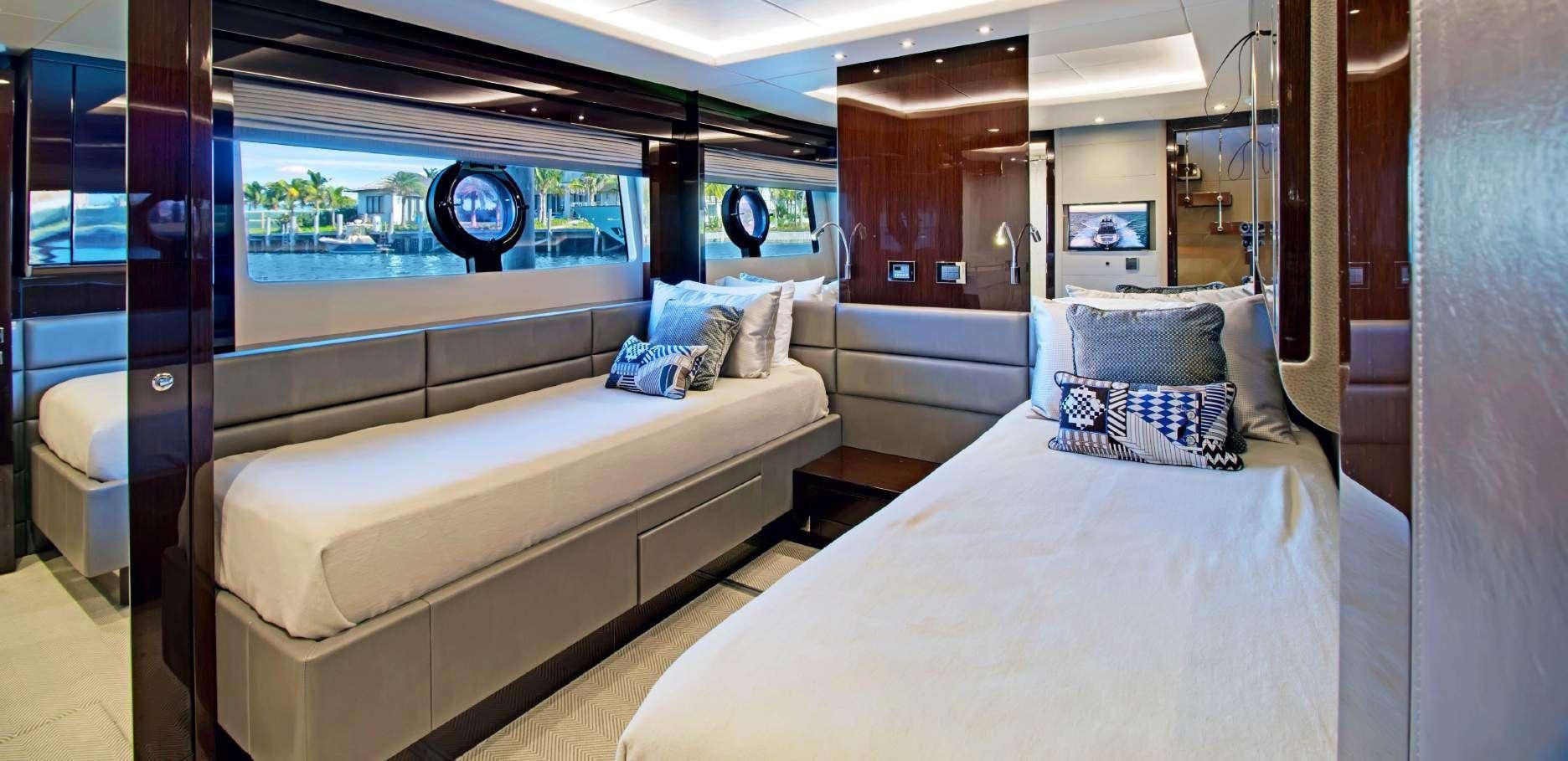 a room with a bed and a window aboard SYNERGY Yacht for Charter