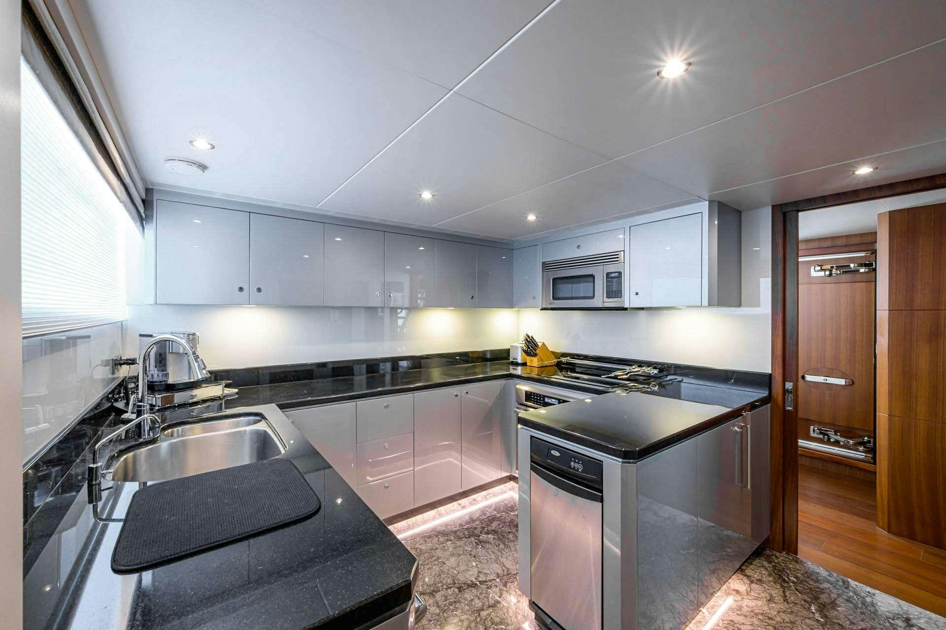 a kitchen with white cabinets aboard ZEPHYR Yacht for Charter