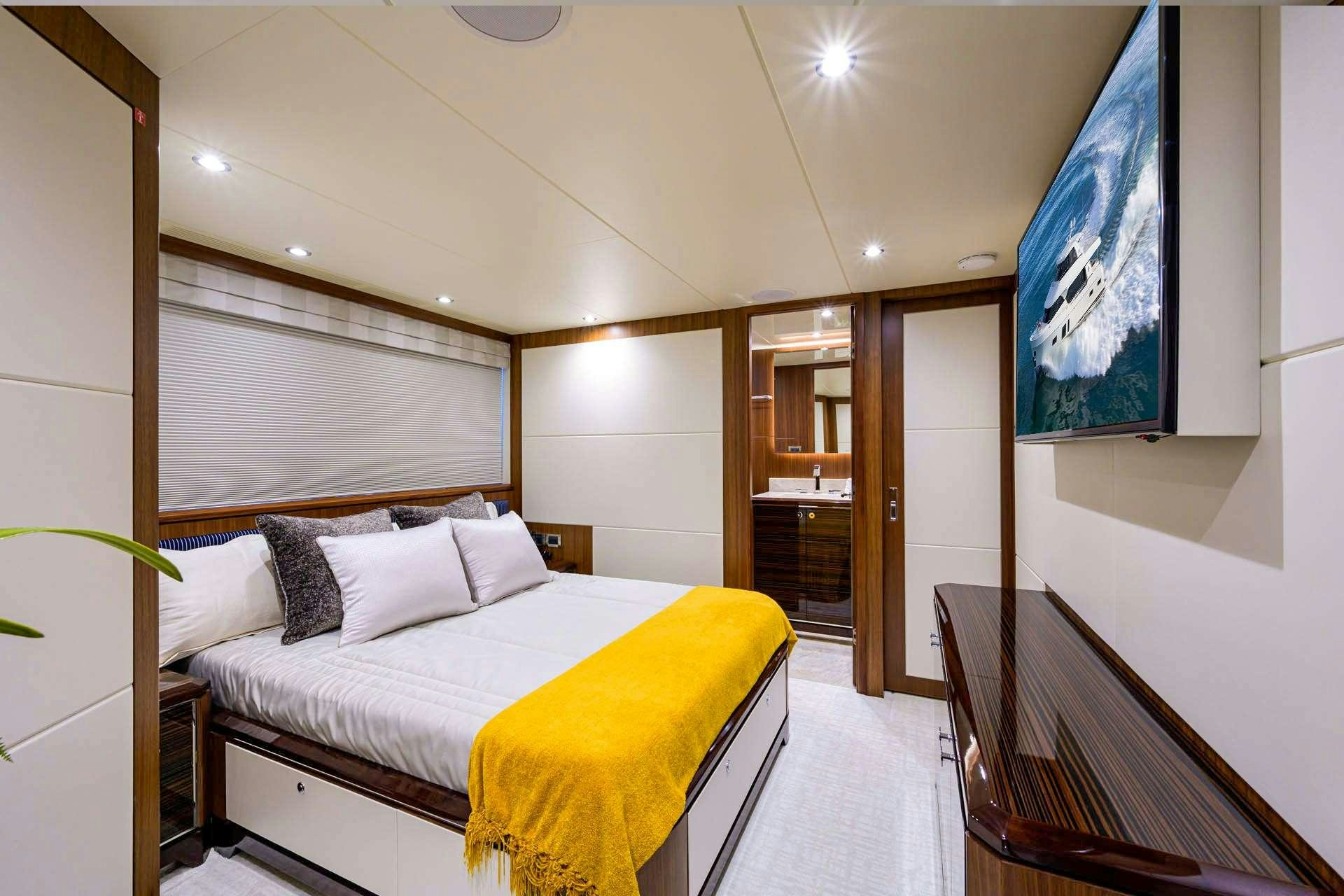 a room with a bed and a chair aboard ZEPHYR Yacht for Charter