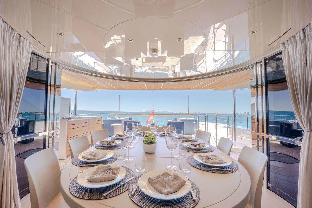 a large dining room with a large window aboard PHOENIX Yacht for Charter