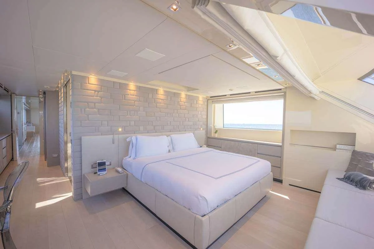 a room with a bed and a window aboard PHOENIX Yacht for Charter