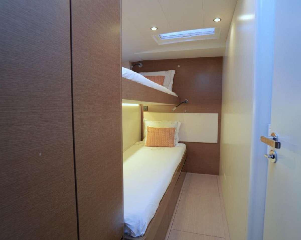 a room with a bed and a closet aboard AENEA Yacht for Charter