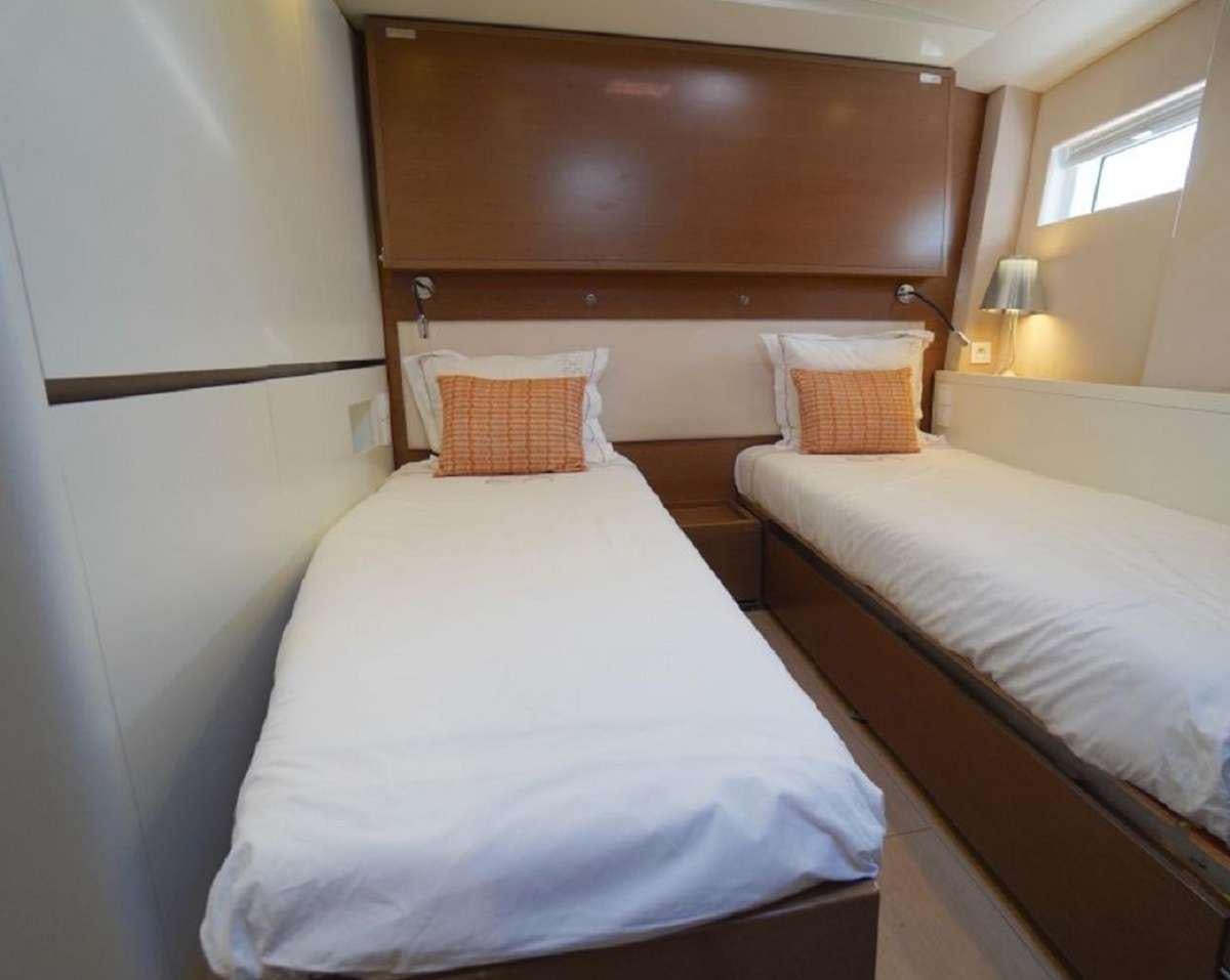 a couple of beds in a hotel room aboard AENEA Yacht for Charter
