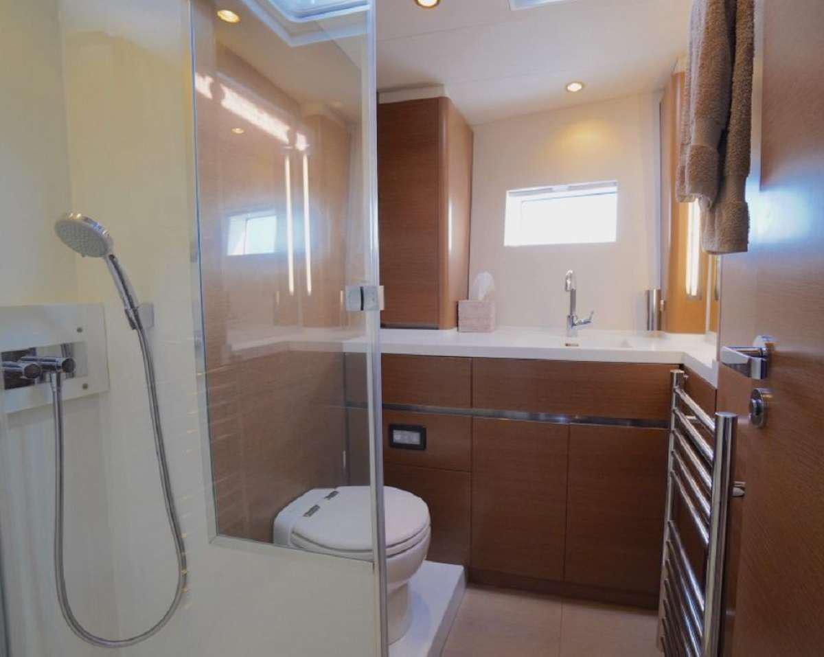 a bathroom with a shower unit and toilet aboard AENEA Yacht for Charter