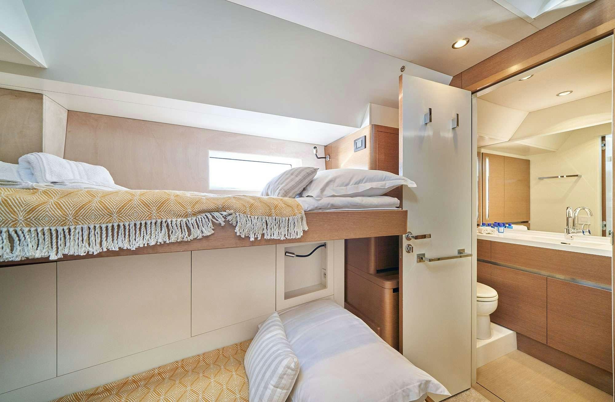 a bedroom with a bed and a sink aboard AENEA Yacht for Charter
