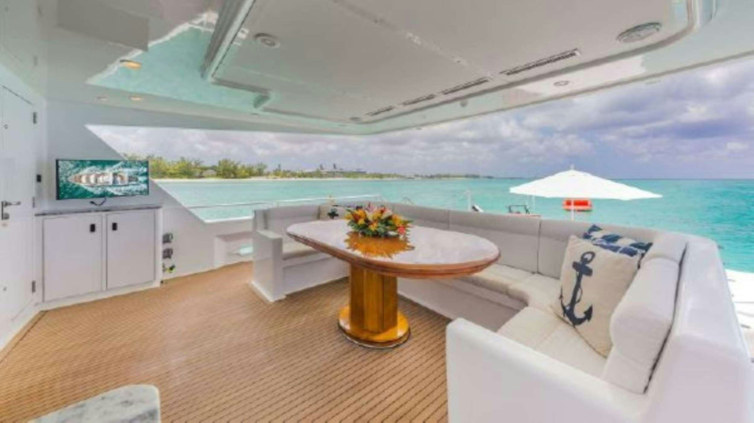 a room with a table and chairs and a pool aboard ROGUE Yacht for Charter