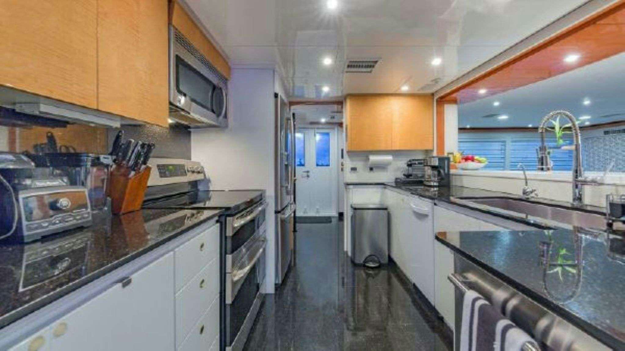 a kitchen with stainless steel appliances aboard ROGUE Yacht for Charter