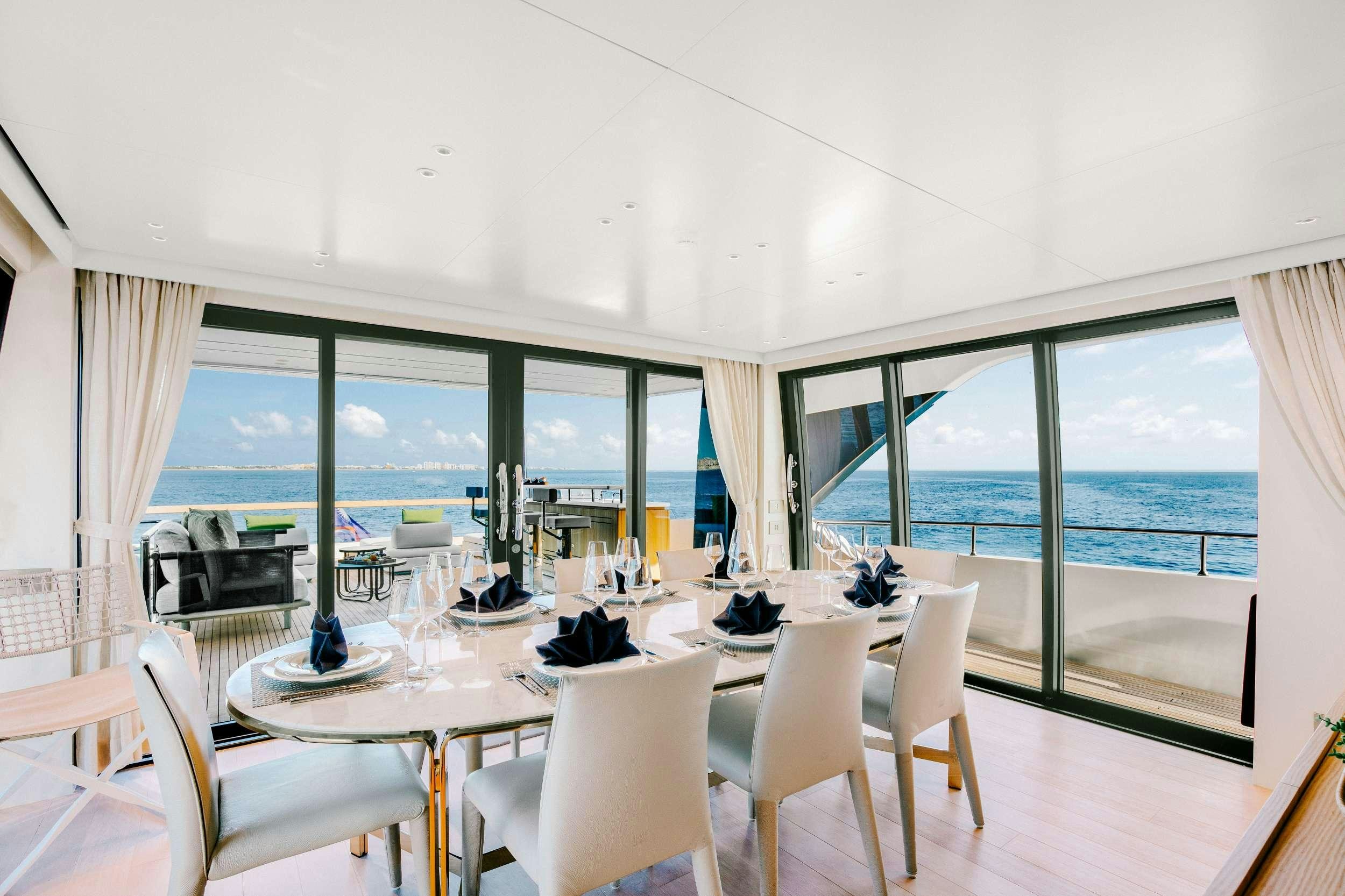 a room with a table and chairs aboard PEARL Yacht for Charter