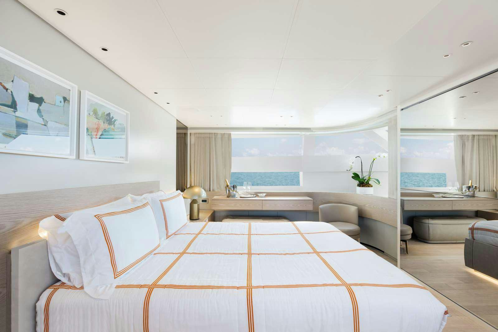 a modern bedroom with a large bed aboard PEARL Yacht for Charter