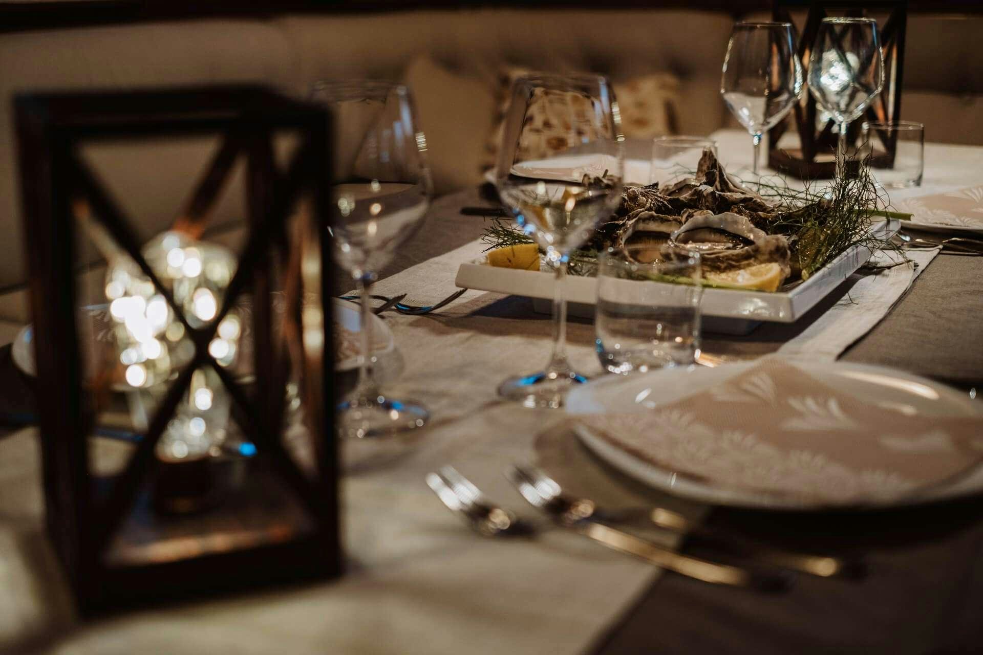 a dinner table with a fireplace aboard HANDE CAPO GALERA Yacht for Charter