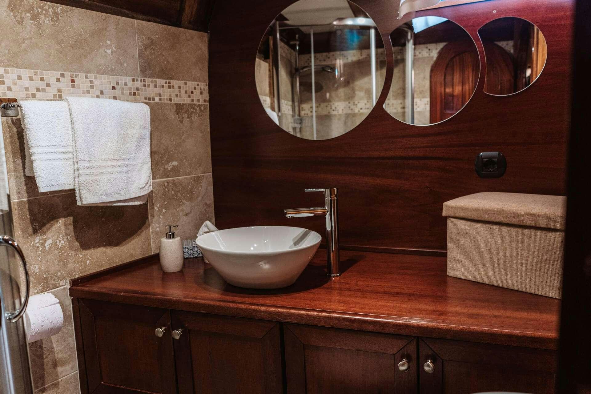 a bathroom with a sink and mirror aboard HANDE CAPO GALERA Yacht for Charter