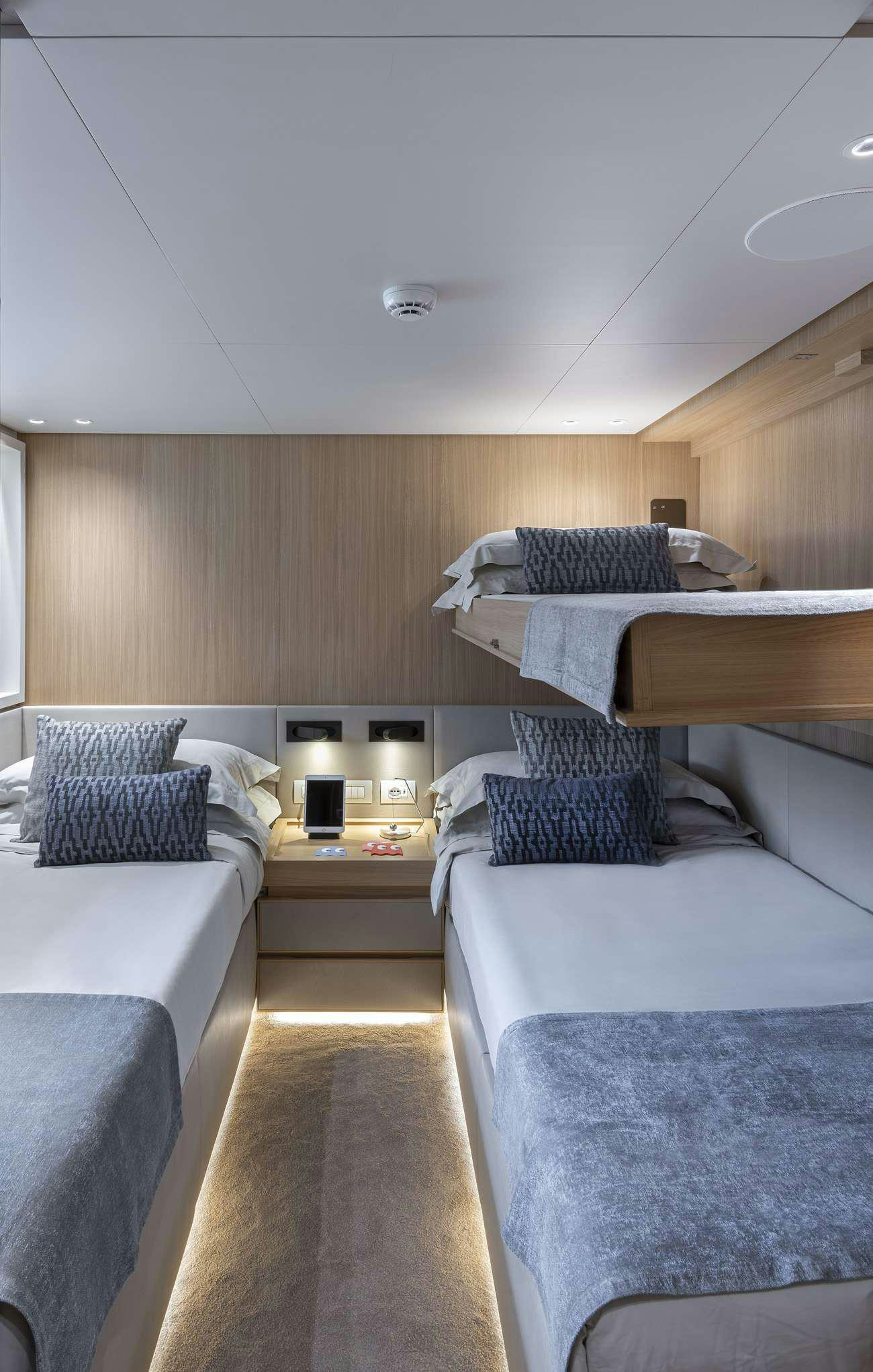 a room with beds and a table aboard FATSA Yacht for Charter