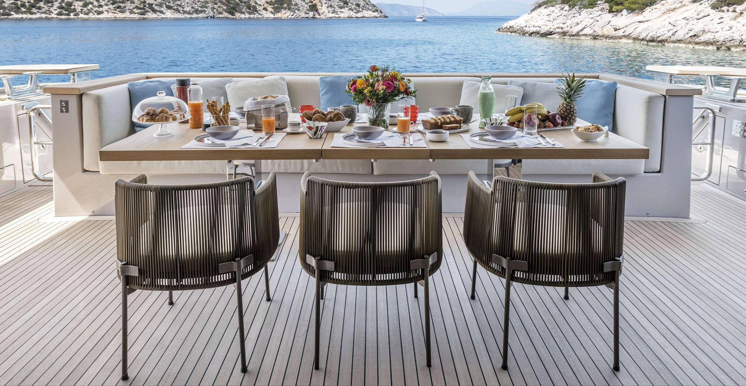a table set with chairs and a view of the water aboard FATSA Yacht for Charter