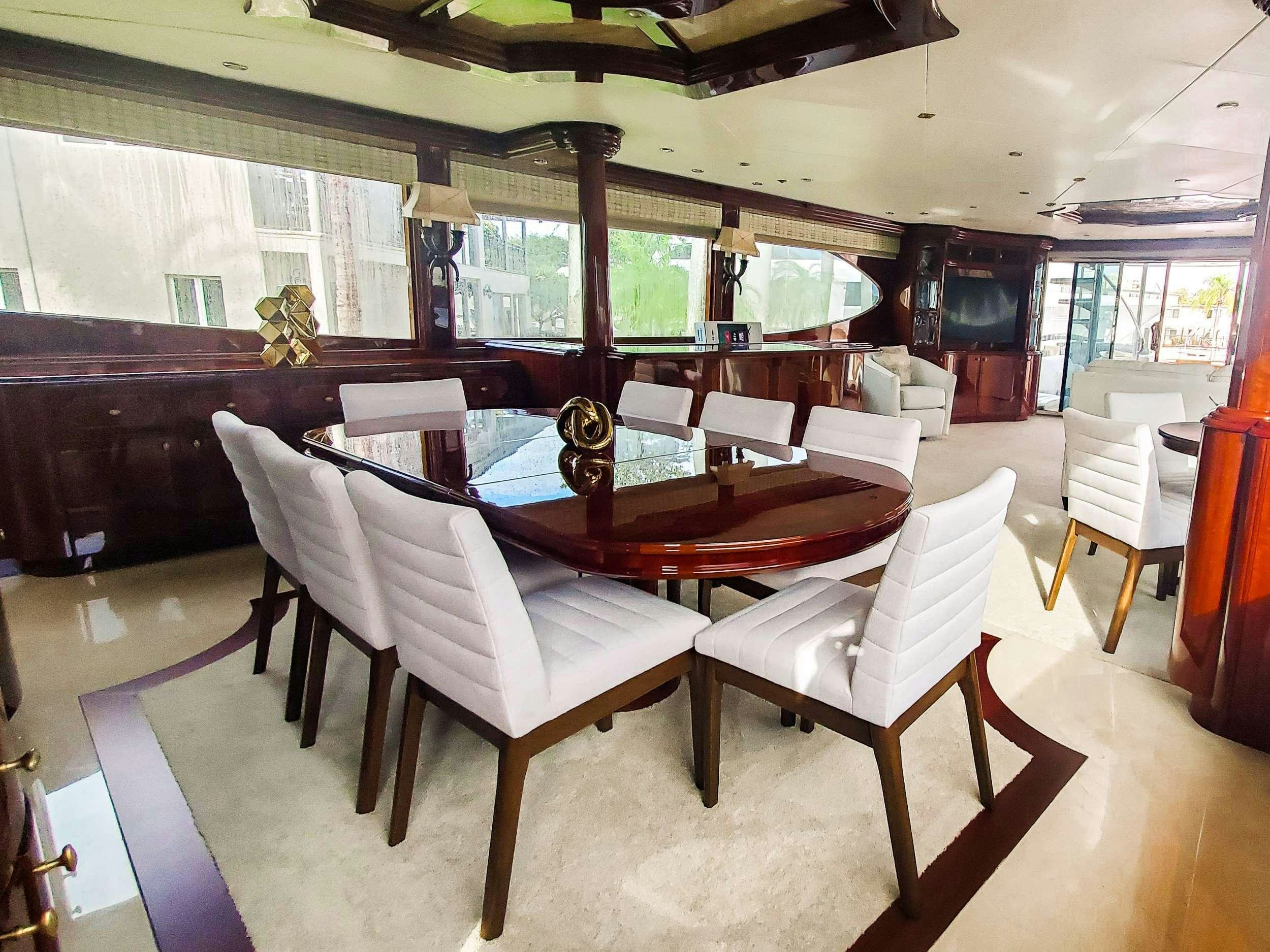 a large room with a table and chairs aboard LADY KRISTINA Yacht for Charter