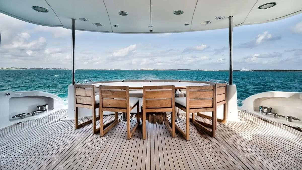 a table and chairs on a deck aboard LADY KRISTINA Yacht for Charter