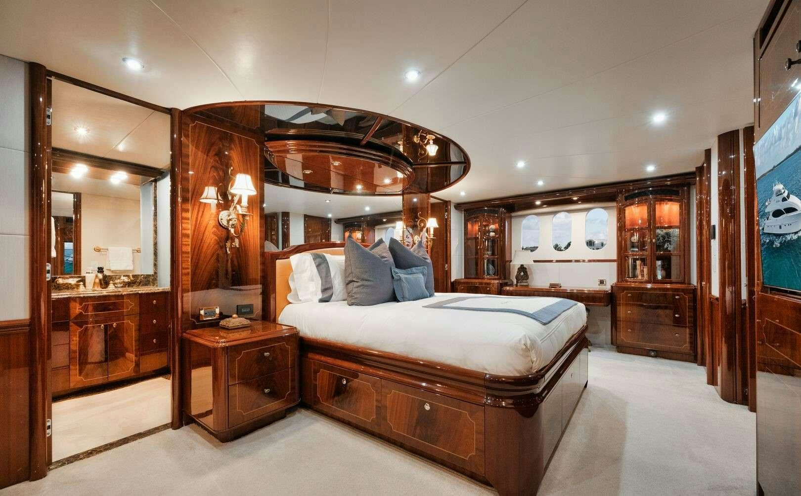a bedroom with a bed and a mirror aboard LADY KRISTINA Yacht for Charter