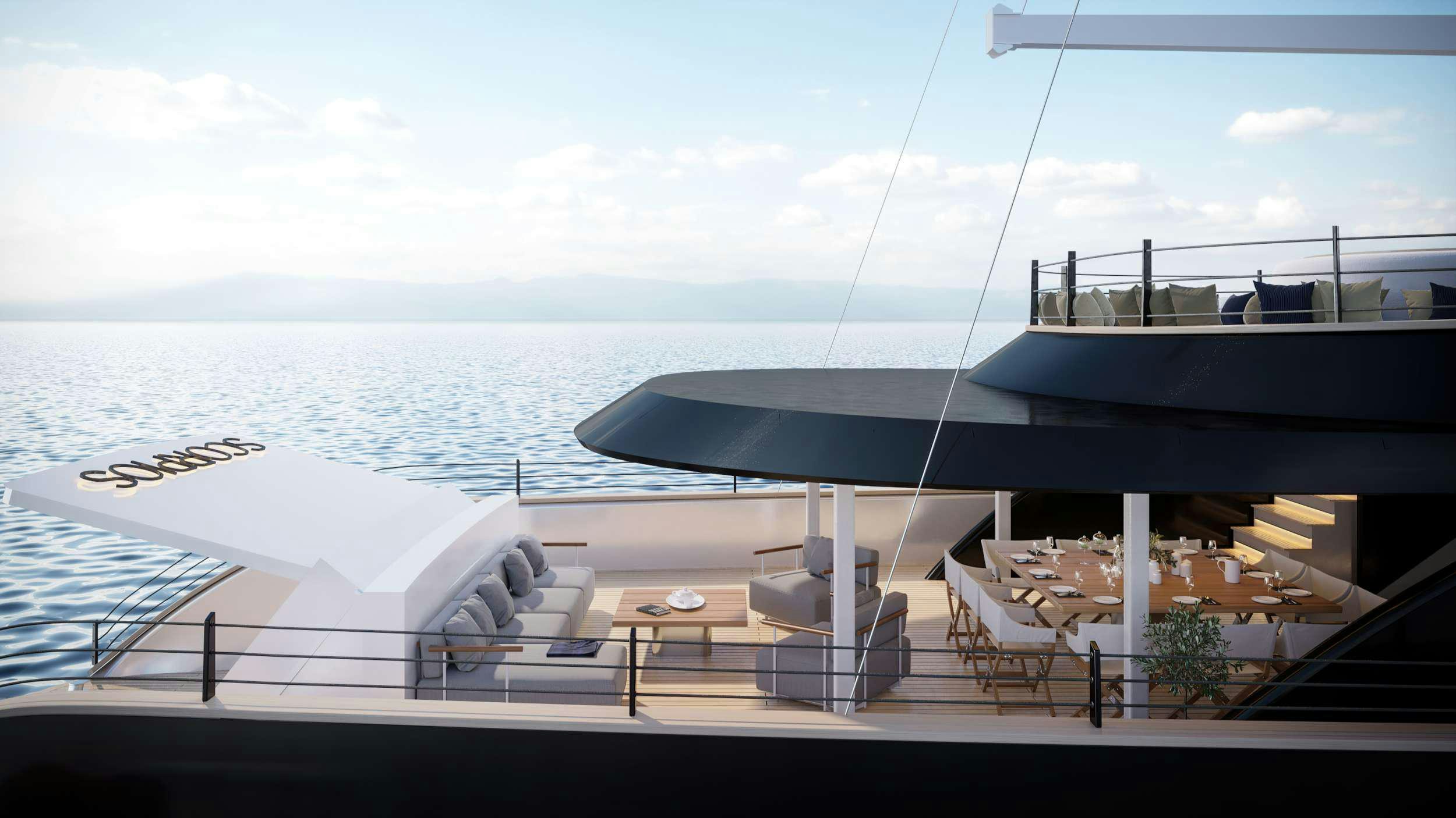 a deck with a view of the ocean and a large boat aboard SCORPIOS Yacht for Charter