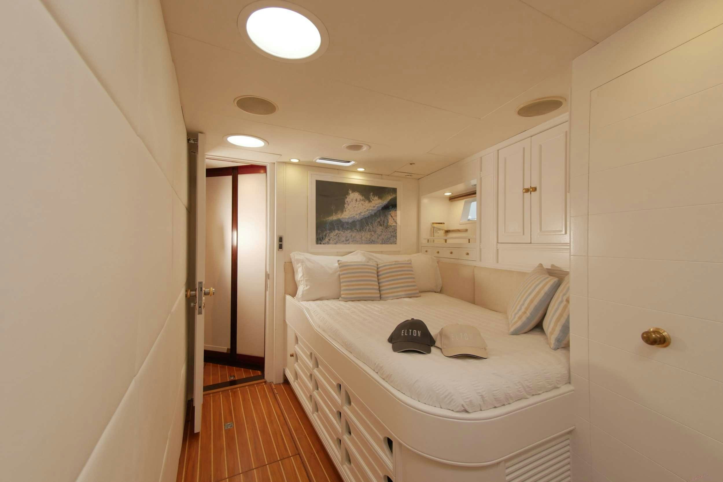 a bedroom with a bed and a desk aboard ELTON Yacht for Charter