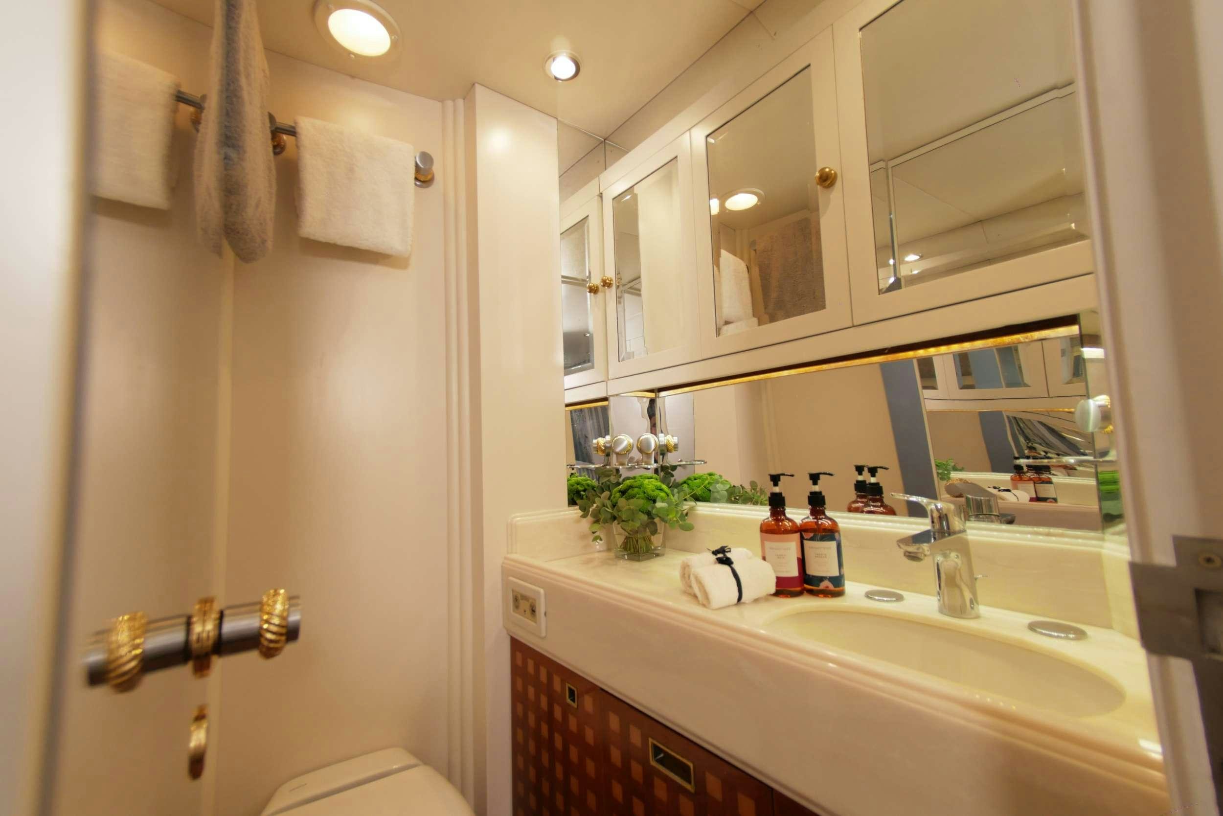 a bathroom with a sink and mirror aboard ELTON Yacht for Charter