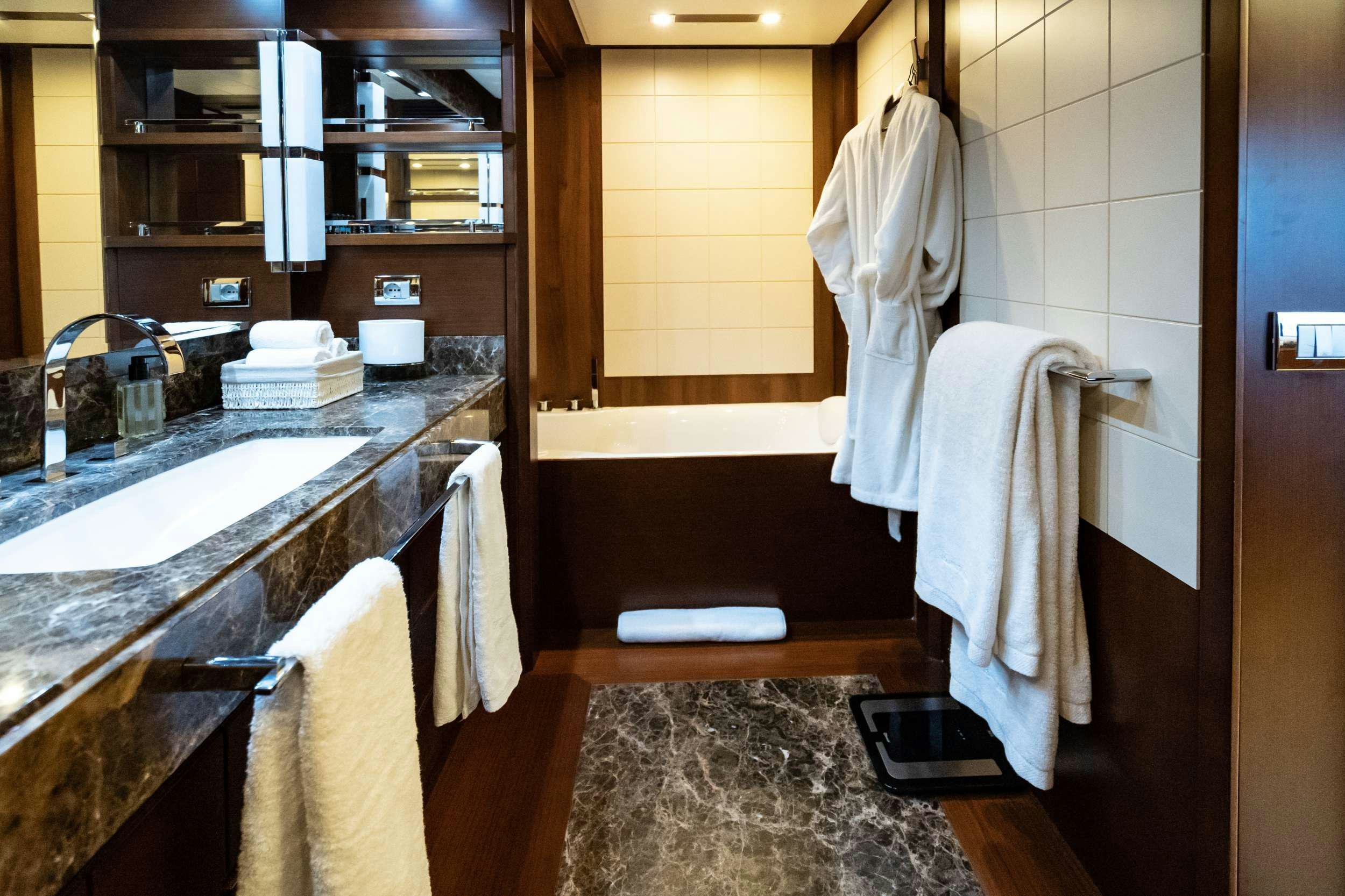 a bathroom with a sink and towels aboard KOUKLES Yacht for Charter