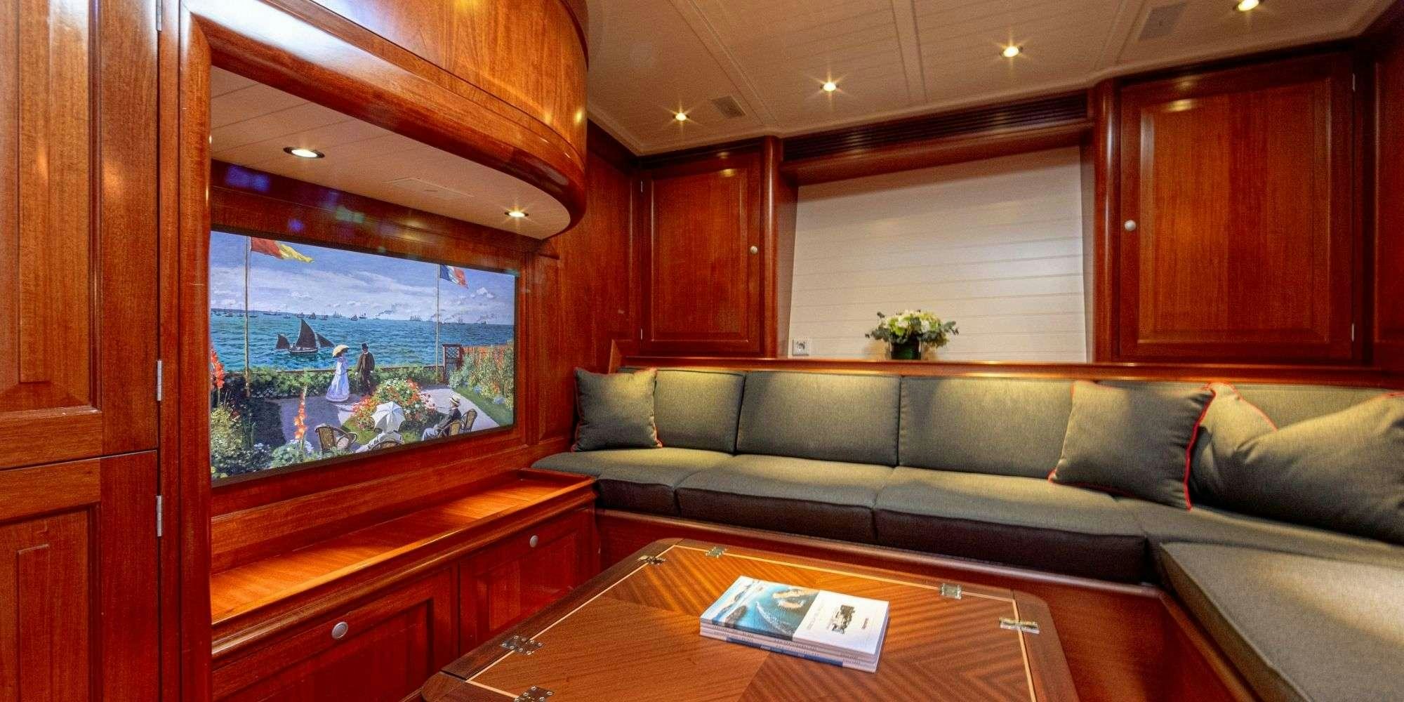 a living room with a couch and a table aboard ATALANTE Yacht for Charter
