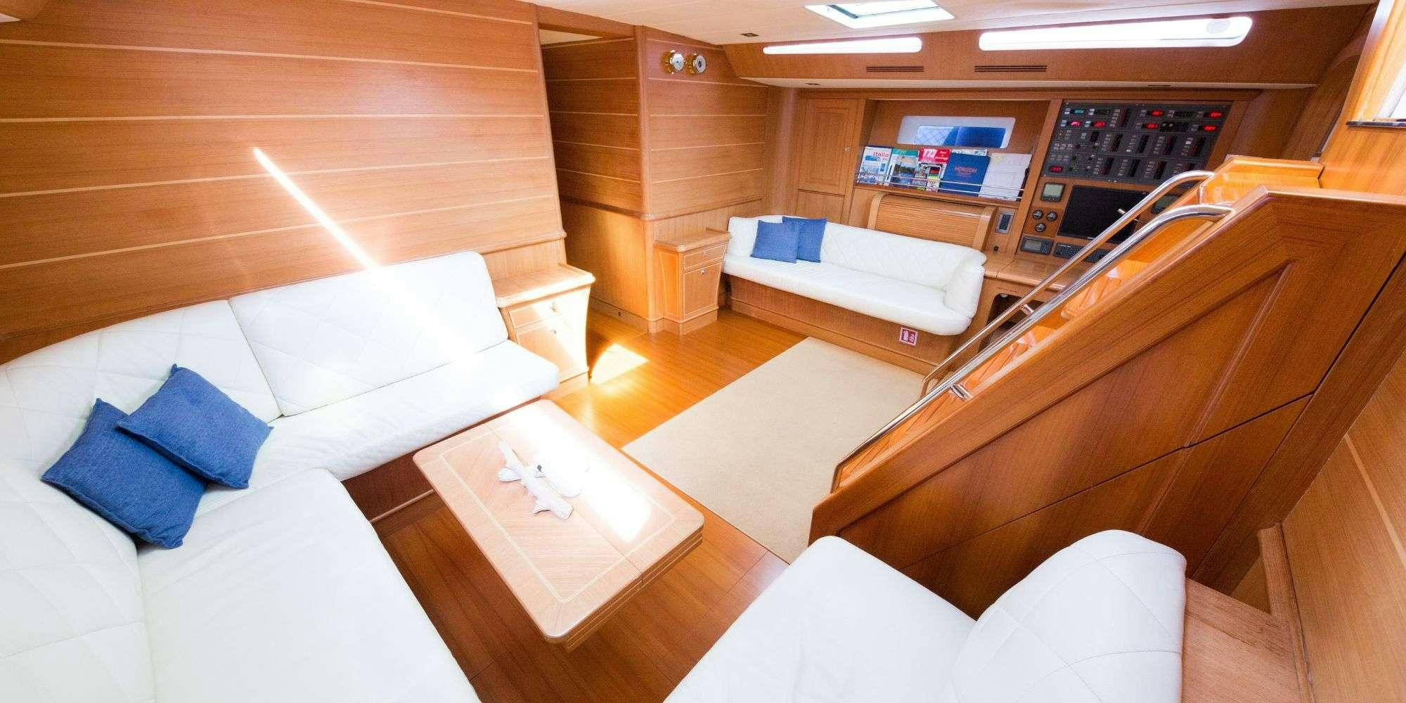 a room with a couch and a table aboard LA VIDELLE Yacht for Charter